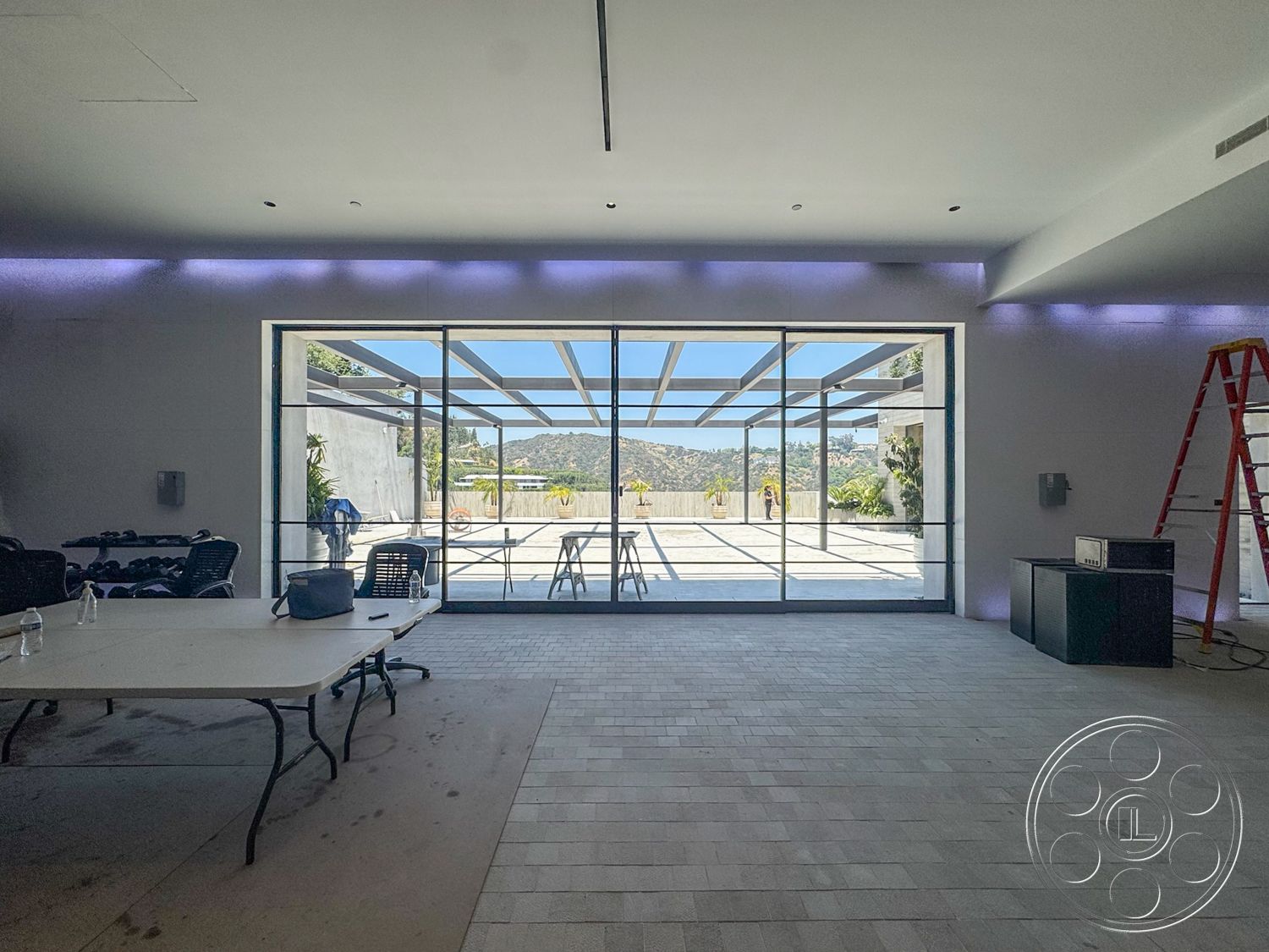Star Villa - mountain view setting, concrete patio flooring, open floor plan layout, contemporary furniture style, minimalist architectural style, floor-to-ceiling glass walls, soft lighting accents, modern ceiling design, rectangular dining area, metal support structure