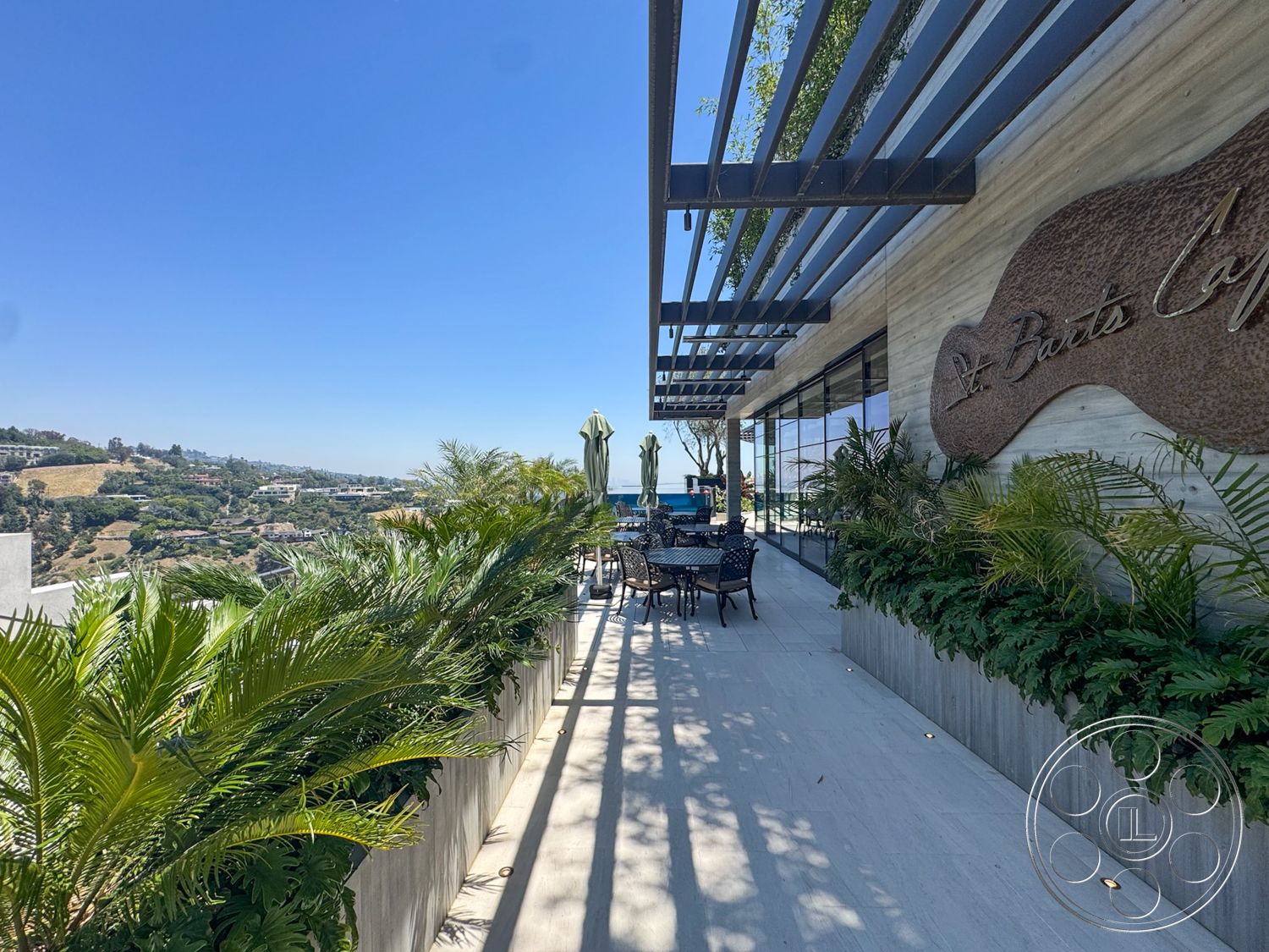 Star Villa - slate flooring, outdoor dining area, modern architectural style, stone feature wall, glass storefront windows, panoramic hillside view, exterior terrace, metal pergola structure, potted palm plants