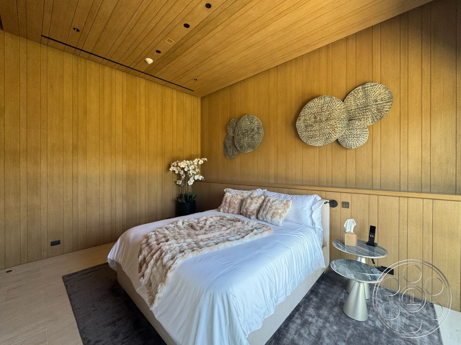 Star Villa - minimalist decor, neutral color palette, plush bedding, floor-to-ceiling windows, decorative wall art, soft area rug, textured throw blanket, modern nightstand, wood paneling walls, horizontal wood ceiling, marble nightstand surface, potted orchids