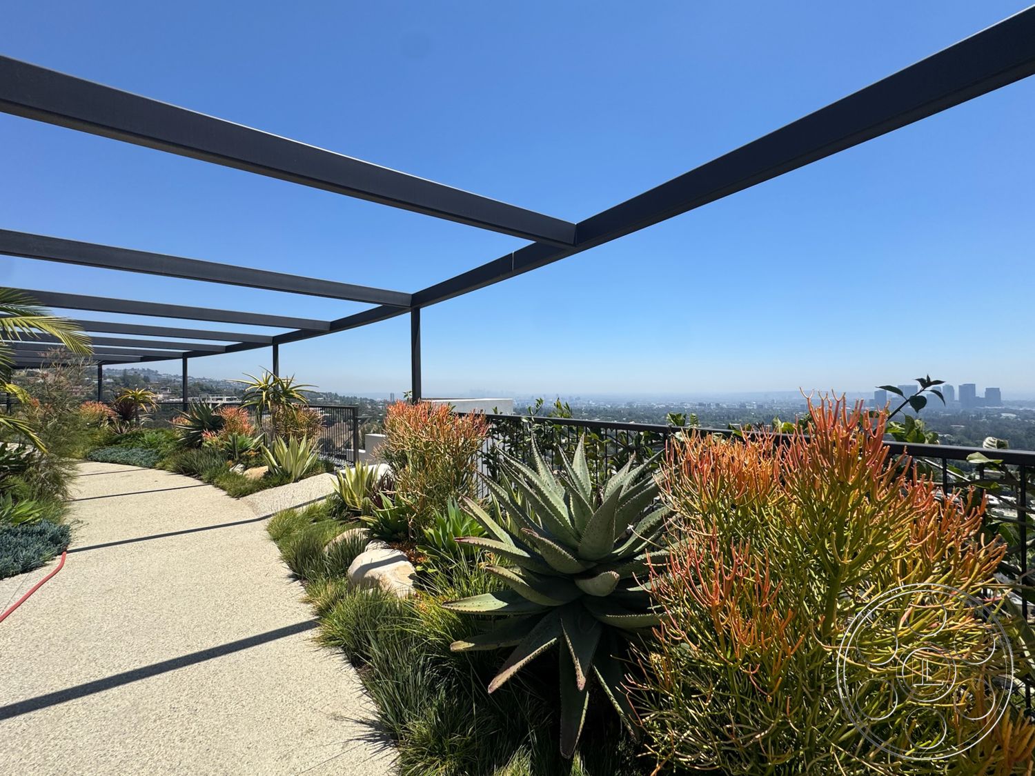 Star Villa - exterior, landscaped garden, concrete pathway, panoramic city view, succulent plants, hillside location, open sky, drought-resistant foliage, metal pergola frame, designed for outdoor living