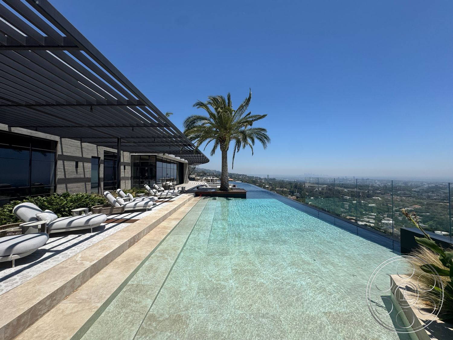 Star Villa - exterior, wooden deck, clear blue sky, infinity pool, landscape greenery, metal pergola, panoramic hillside view, glass pool fencing, modern outdoor lounge chairs, marble pool deck, concrete patio steps