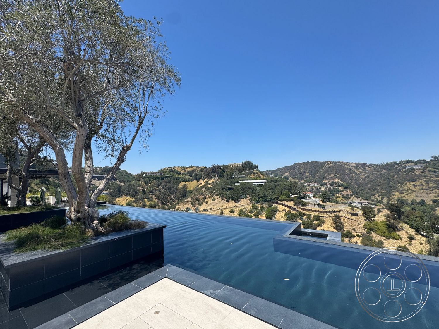 Star Villa - exterior, landscaped terrace, mountain view, infinity pool, urban hillside location, contemporary home design, slate stone pool border, woodland environment