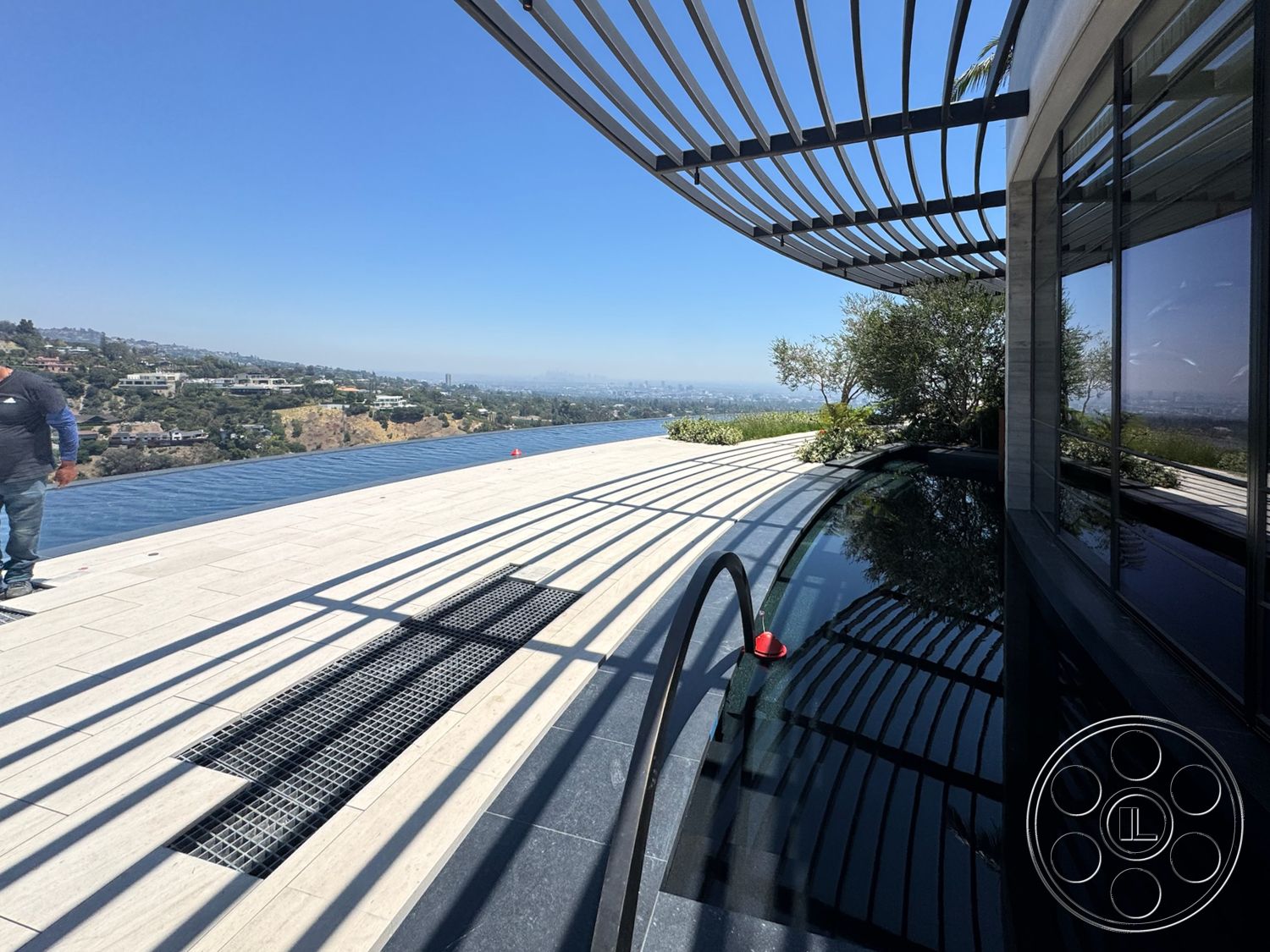 Star Villa - exterior, landscaped garden, floor-to-ceiling windows, outdoor living space, modern architectural style, city skyline view, infinity pool, metal pergola, sloping hillside, stone pool deck, concrete patio floor, rectangular infinity edge pool