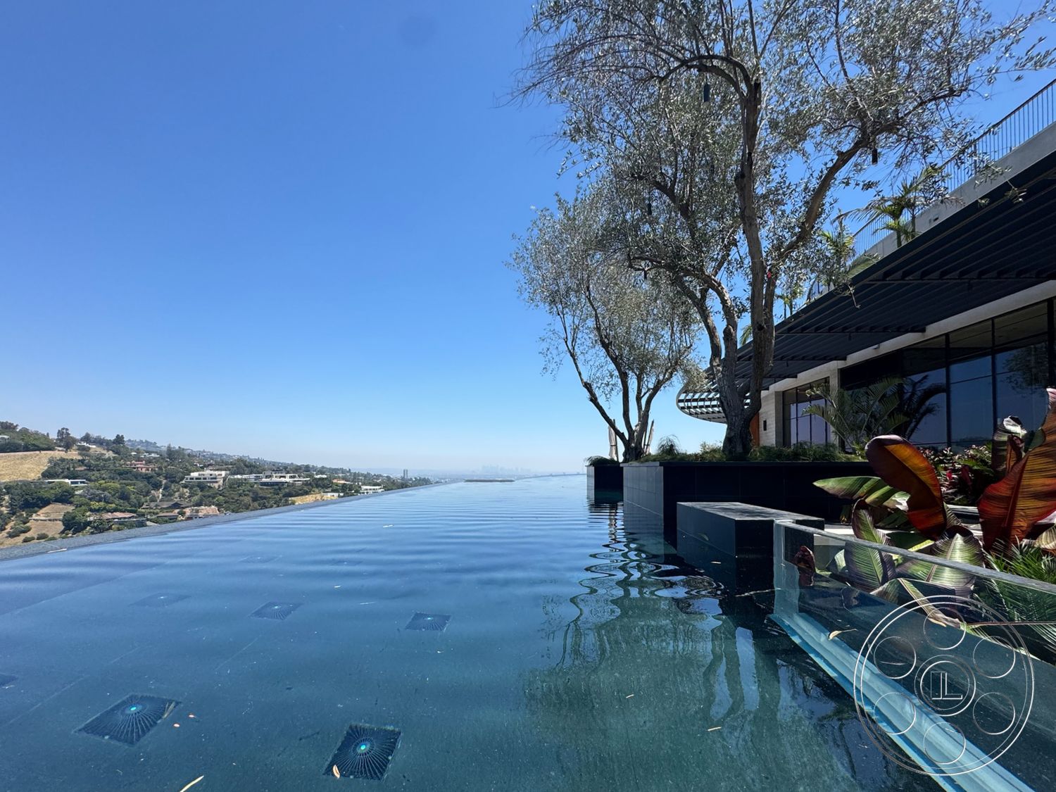 Star Villa - exterior, floor-to-ceiling windows, outdoor lounge area, modern architectural style, panoramic city view, infinity pool, concrete pool deck, landscaped garden beds, urban hillside setting, glass pool edge, steel pergola