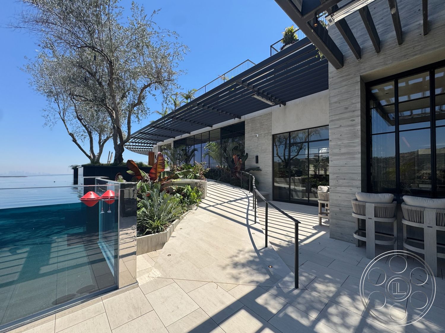 Star Villa - exterior, outdoor seating area, textured concrete walls, modern landscaping, rectangular swimming pool, floor-to-ceiling windows, steel railings, natural stone planters, concrete patio flooring, glass pool edge, horizontal wood pergola, sloped pathway