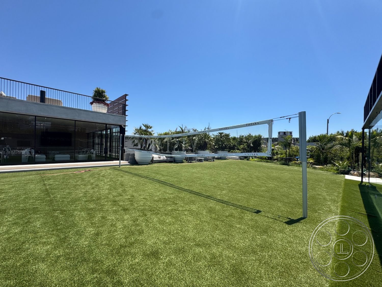 Star Villa - exterior, landscaped garden, modern architecture, minimalist design elements, urban setting, potted greenery, open outdoor space, artificial turf lawn, stainless steel railing, poolside area, flat roof design, floor-to-ceiling glass windows, concrete patio border, outdoor volleyball court