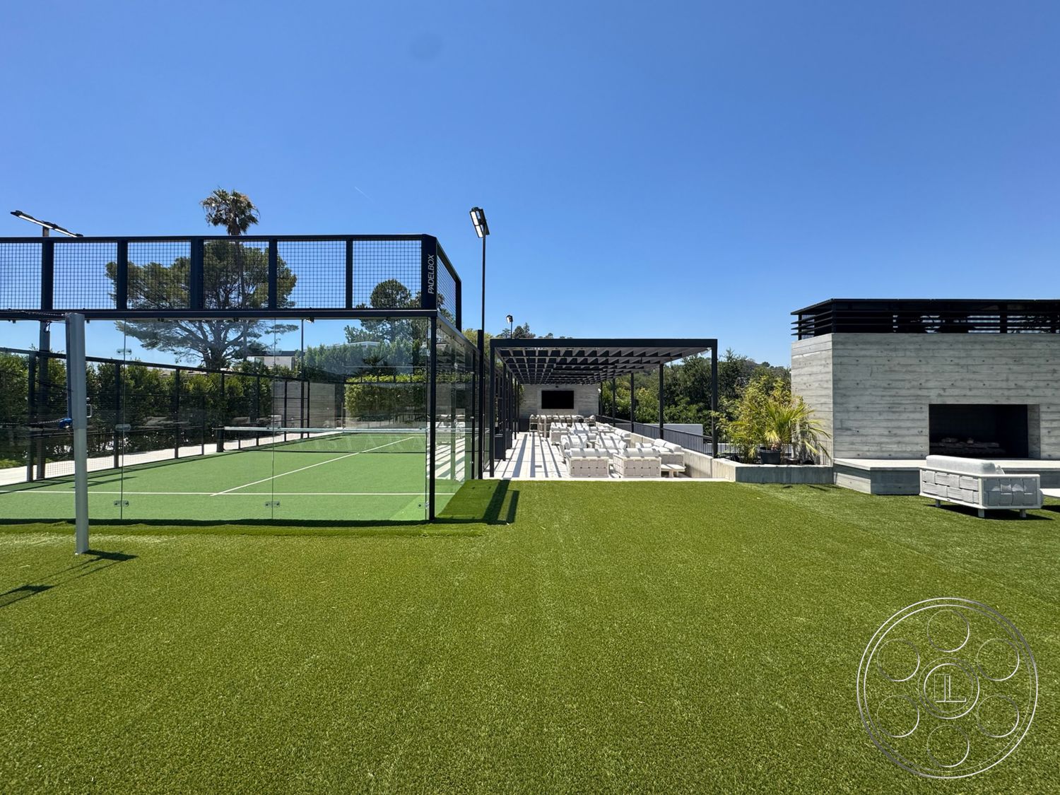 Star Villa - exterior, landscaped greenery, outdoor lounge area, artificial turf lawn, open sky view, concrete outdoor seating area, glass wall enclosure, metal frame pergola, modern concrete fireplace, rectangular outdoor seating arrangement