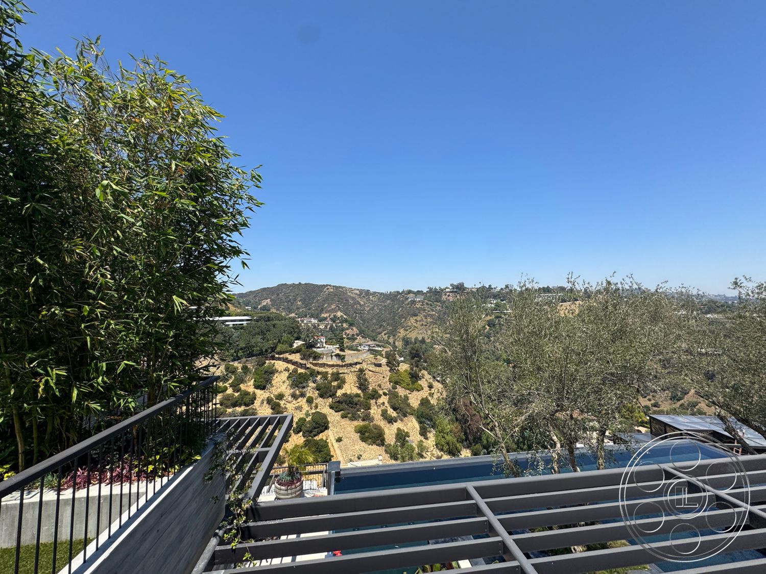 Star Villa - exterior, metal railing, modern architectural style, wood deck, mountain view setting, landscaped garden area, bamboo privacy screen, multi-level outdoor space, concrete terrace floor