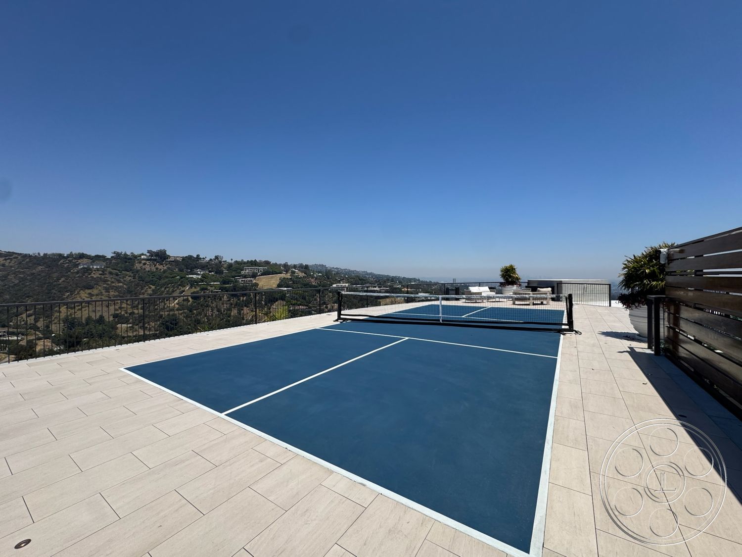 Star Villa - exterior, metal railing, mountain view, landscape greenery, expansive outdoor space, open sky, stone patio flooring, blue tennis court, residential rooftop setting