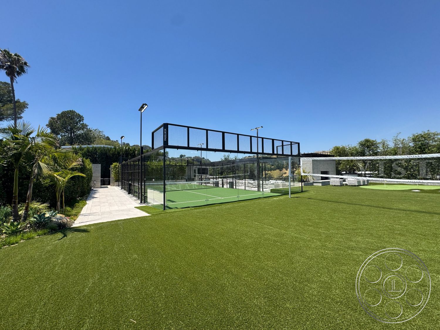 Star Villa - exterior, steel frame structure, outdoor lighting fixtures, smooth concrete pathway, landscaped garden area, contemporary outdoor setting, synthetic grass lawn, concrete pavers patio, glass enclosure for sports court, modern sports court, turf sports field, fenced sports area