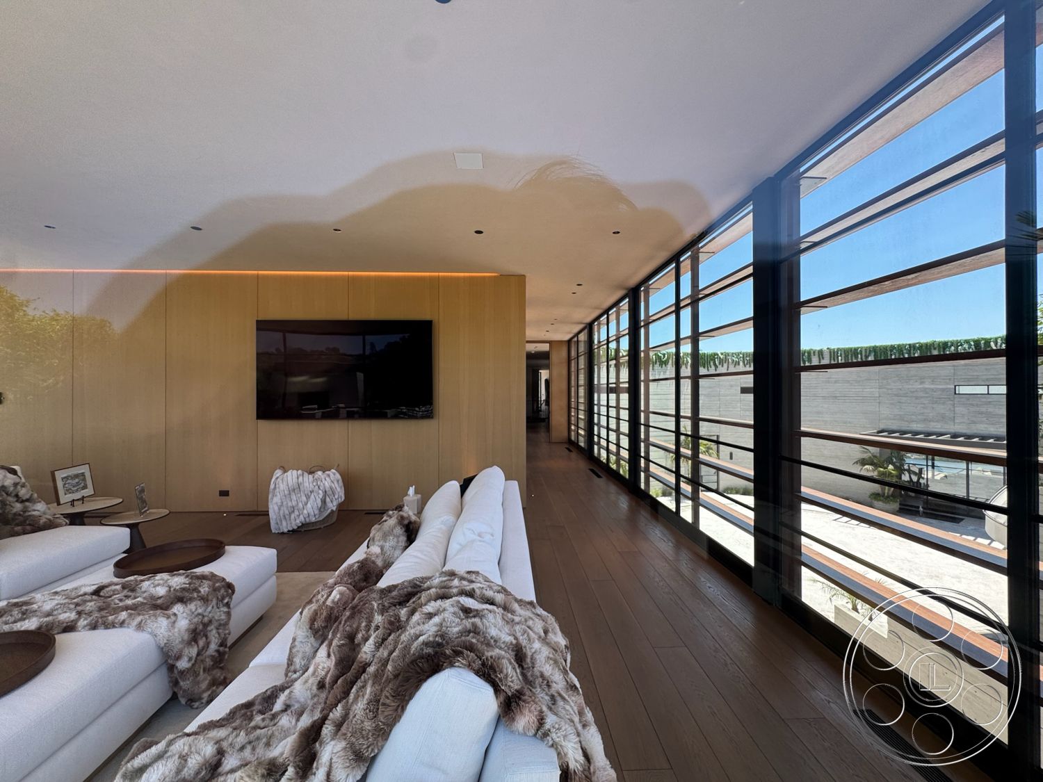 Star Villa - natural light, clean lines, floor-to-ceiling windows, open-concept living space, textured wall treatments, large flat-screen television, stylish decor elements, modern sofa, wood paneling walls, ambient LED lighting, contemporary side table, floating wood floors, soft fur throw blankets, minimalist design accents