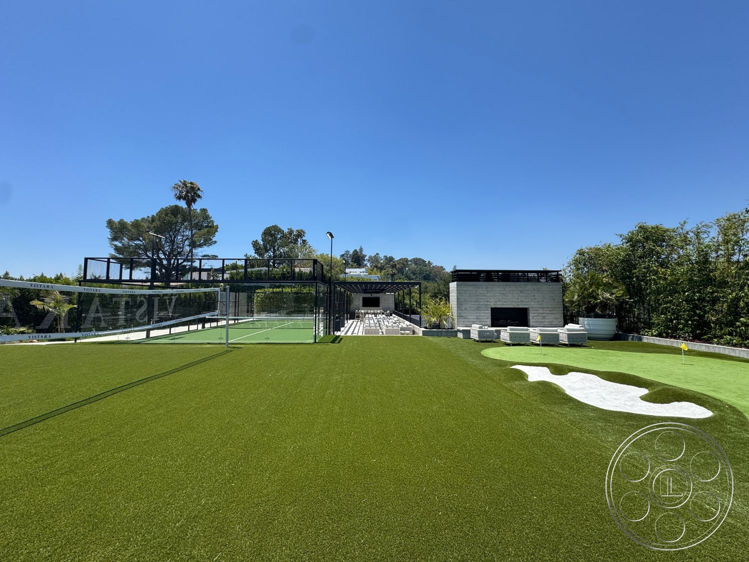Star Villa - exterior, potted plants, modern landscape design, stone feature wall, concrete patio flooring, wood pergola structure, artificial grass lawn, clear blue sky setting, rectangular tennis court, open terrace seating area, green garden surroundings