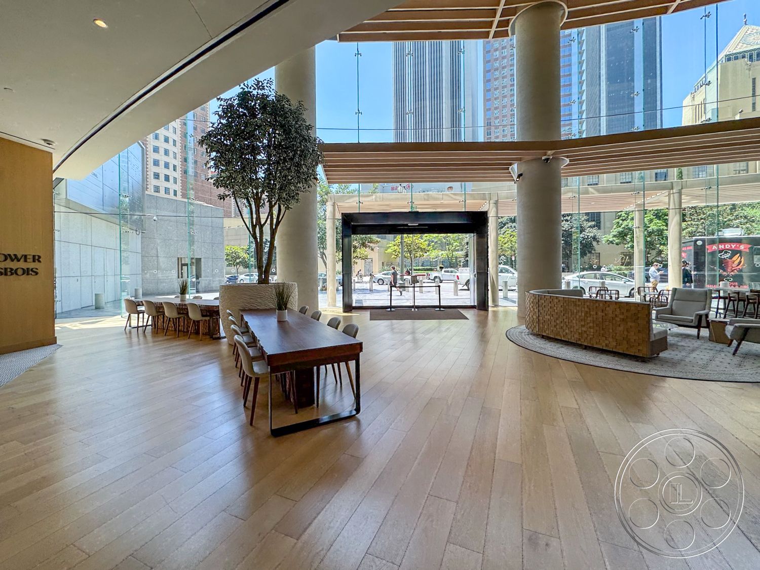 Office 123 - hardwood flooring, minimalist design, open floor plan, upholstered dining chairs, floor-to-ceiling windows, soft area rug, reception area, urban skyline view, indoor greenery, modern dining table, wood beam ceiling, contemporary lounge seating, glass curtain wall, exposed concrete columns