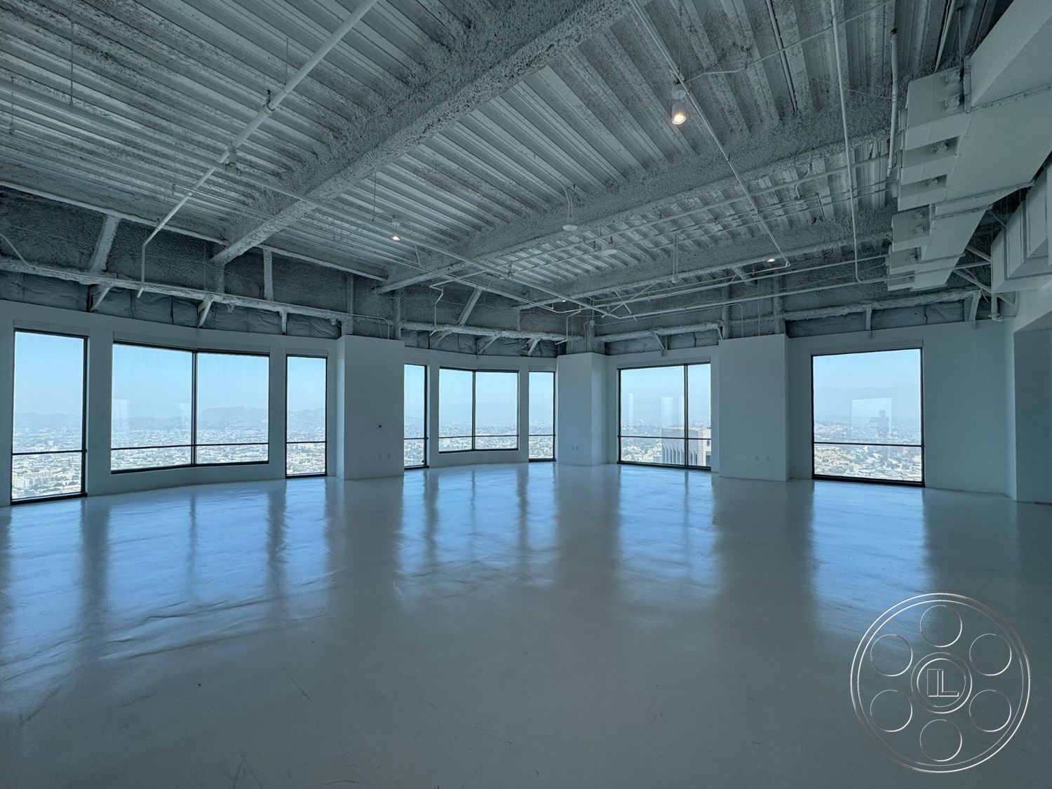Office 123 - high ceilings, open layout, industrial style, concrete floors, exposed ductwork, city skyline view, large floor-to-ceiling windows, white painted walls