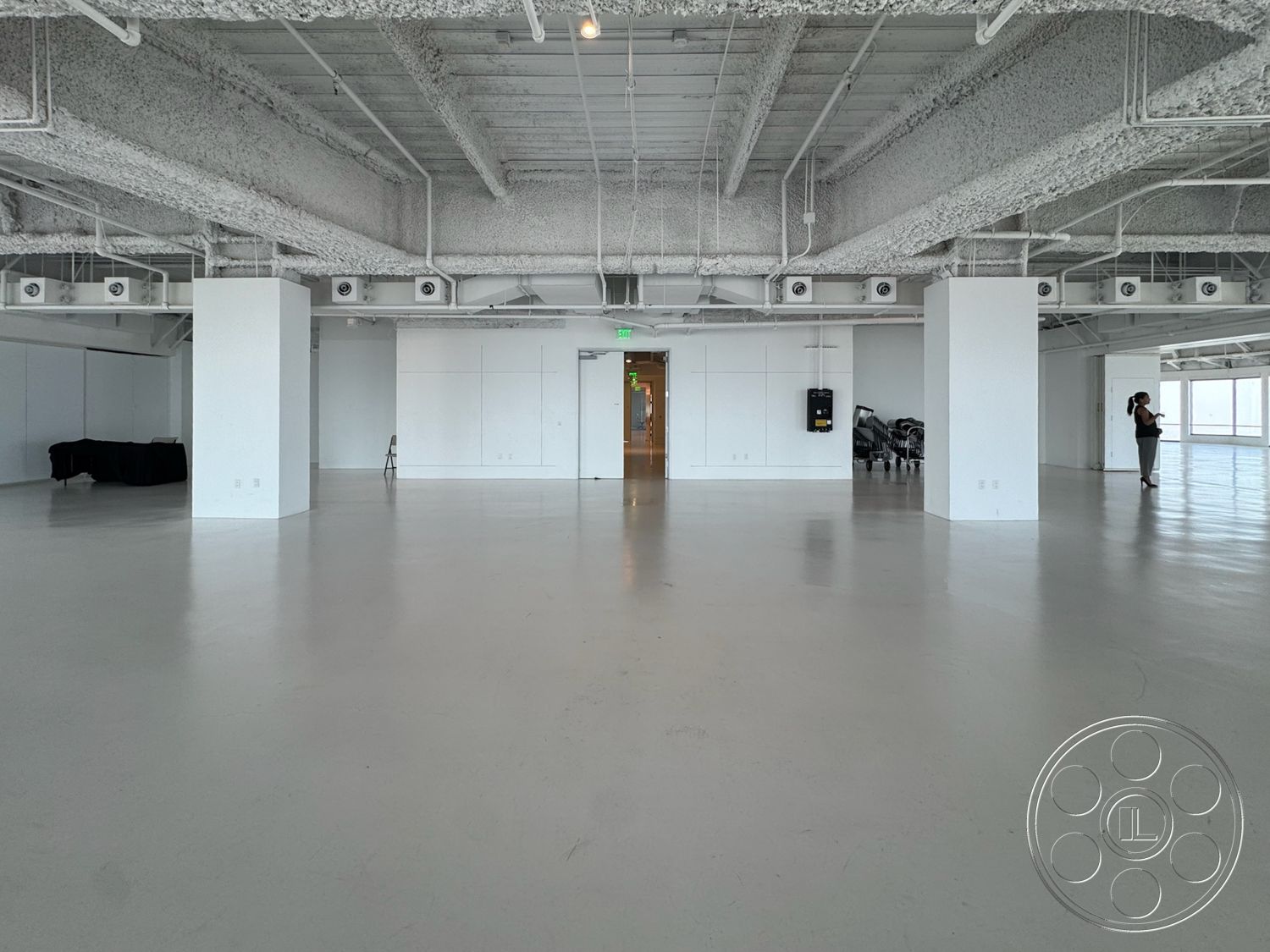 Office 123 - open floor plan, minimalist design elements, smooth concrete flooring, white painted walls, industrial-style architecture, large windows with natural light, exposed concrete ceiling beams, commercial interior space, bright, spacious environment