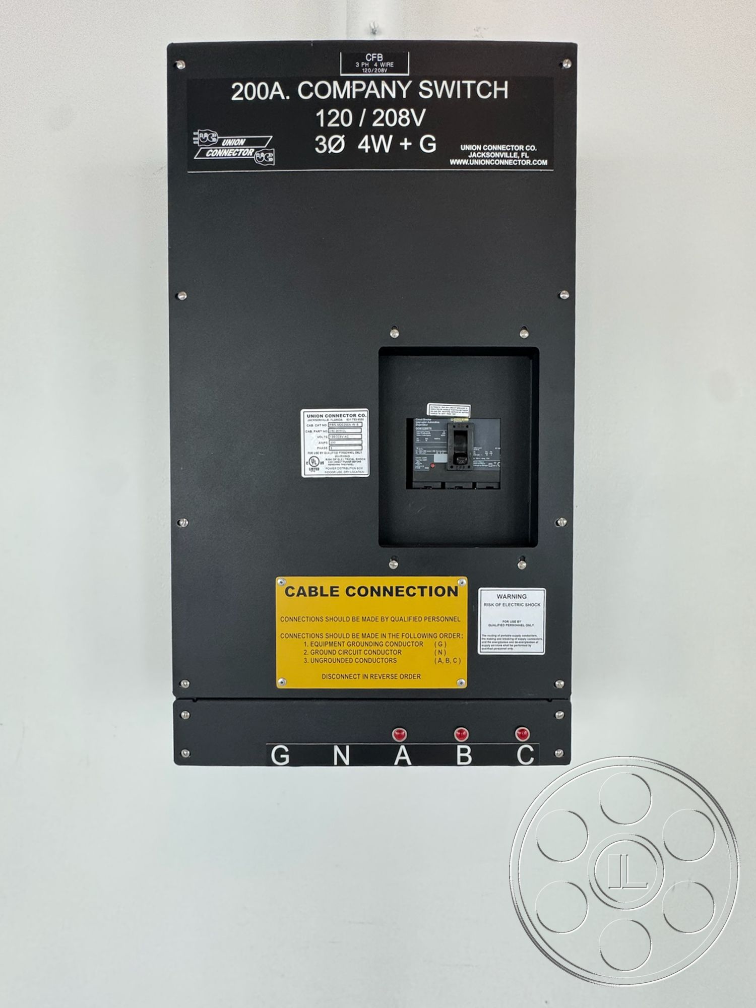 Office 123 - exterior, metal electrical panel, black metal finish, 200 amp switch, warning labels, cable connection instructions, labeled connectors, flat surface mounting