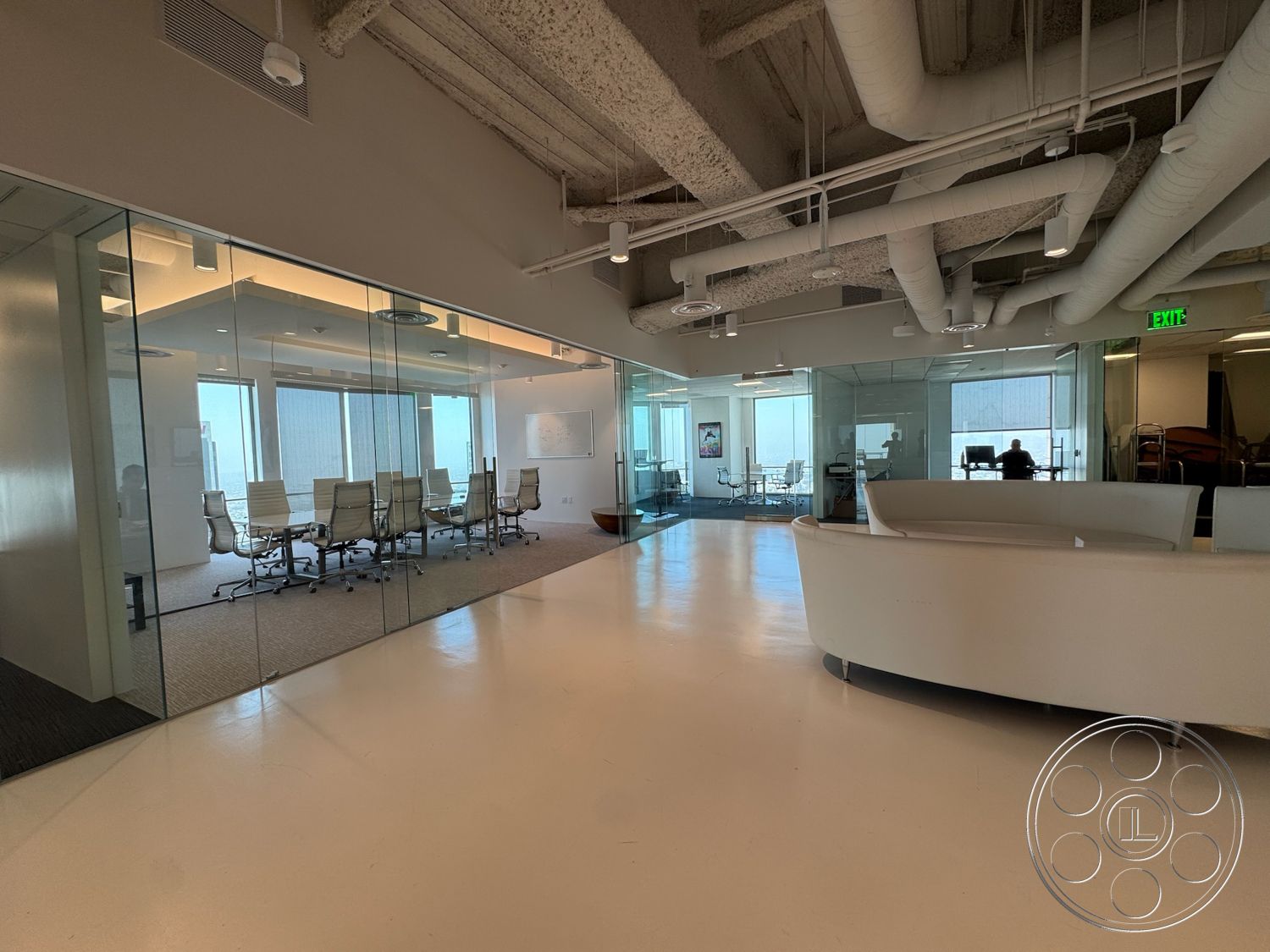 Office 123 - polished concrete flooring, floor-to-ceiling windows, open office layout, task chairs, glass partition walls, white painted walls, natural light exposure, contemporary office design, exposed ductwork ceiling, modern office furniture, boardroom with glass walls, reception area with curved desk