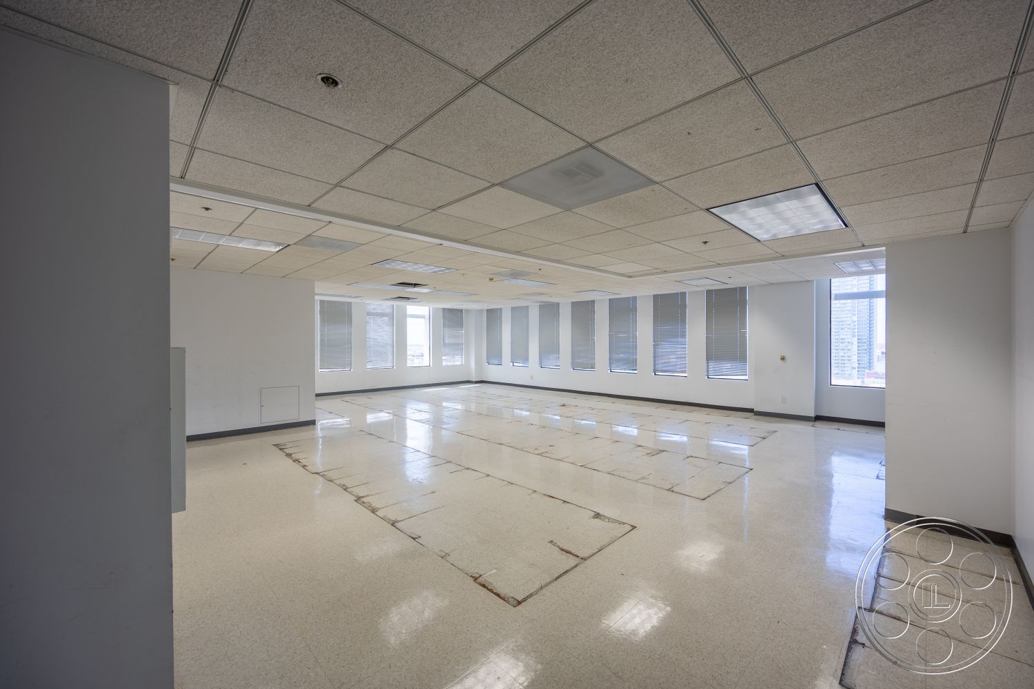 Rooftop 53 - large windows, natural light, polished tile flooring, office space, white painted walls, exposed ceiling tiles