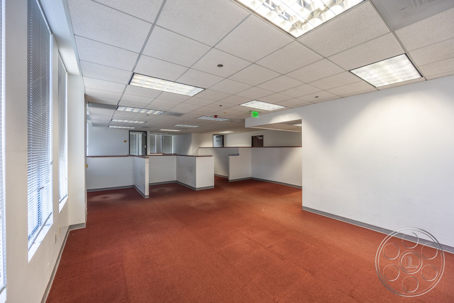 Rooftop 53 - fluorescent lighting, carpet flooring, drop ceiling, white painted walls, interior office space, functional office layout, glass partition windows, cubicle dividers
