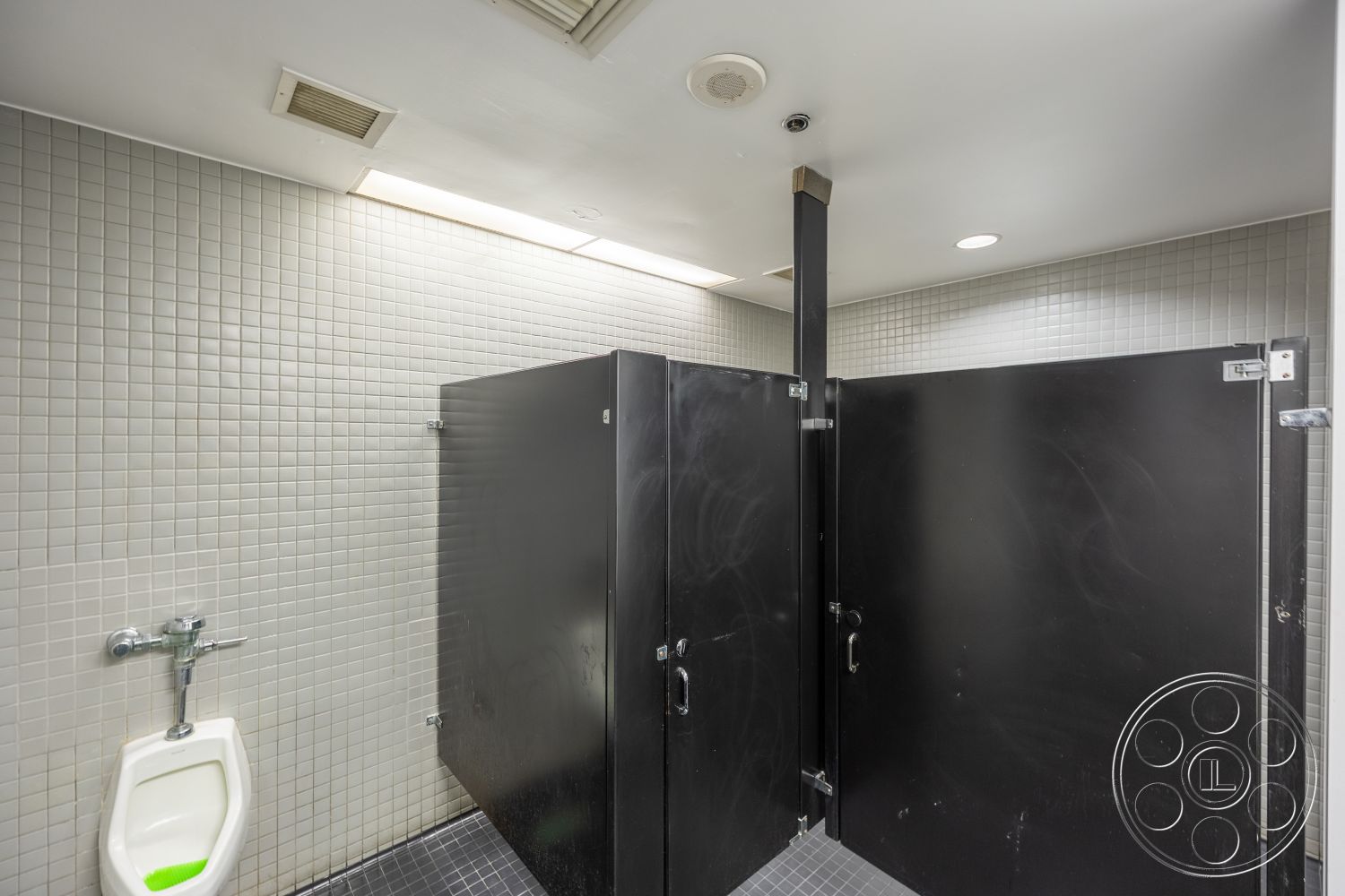 Rooftop 53 - drop ceiling with recessed lighting, interior restroom, modern restroom design, commercial-grade flooring, gray tiled walls, black restroom partitions, urinal with chrome fixtures, square tile wall treatment, clean and functional layout