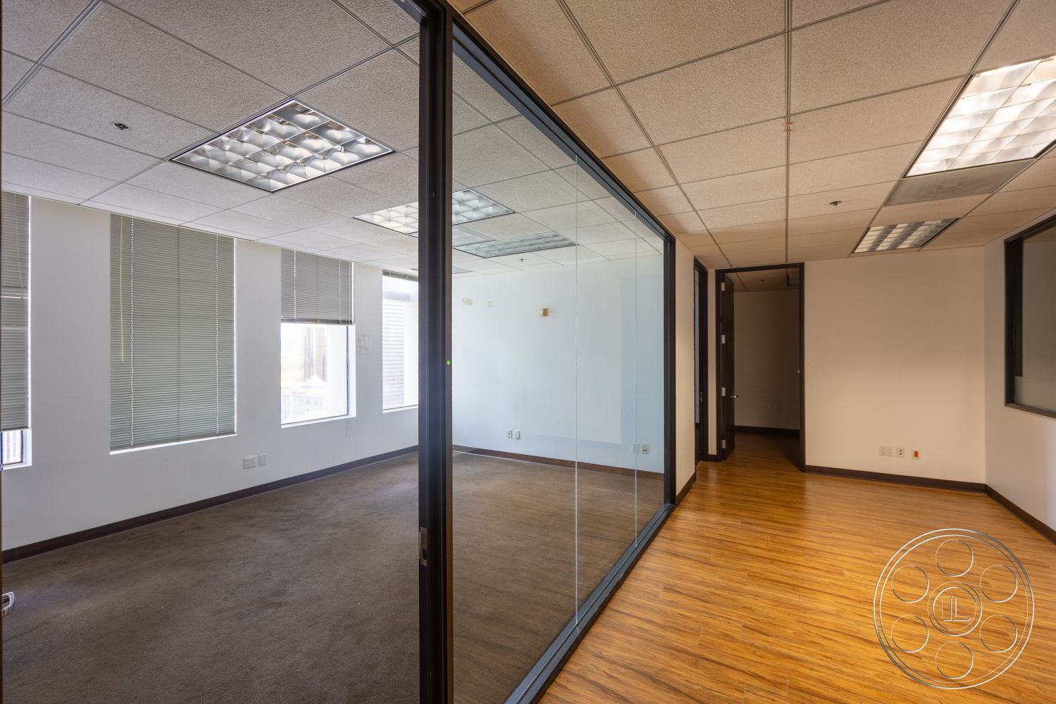 Rooftop 53 - neutral color palette, glass partition walls, textured painted walls, wood laminate flooring, interior office space, drop ceiling tiles, recessed fluorescent lighting, single door entry, blinds on windows, room with multiple windows