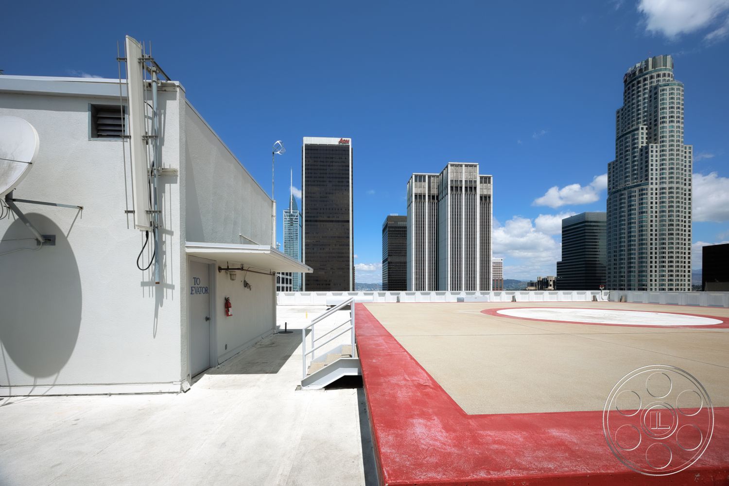 Rooftop 53 - exterior, metal railings, modern architectural style, city skyline view, industrial setting, flat roof design, concrete rooftop, glass skyscrapers, elevator access door, satellite dish installation, red painted helipad border