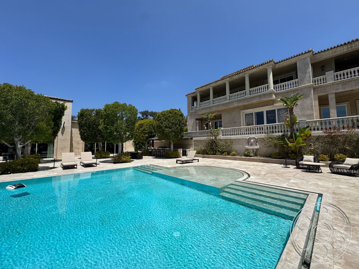 Beverly Compound - large windows, exterior, flat roof, surrounding trees, arched doorways, outdoor lounge chairs, concrete pool deck, rectangular pool, stucco exterior walls, stone patio flooring, patio dining area, landscaped garden with shrubs, balustrade railing, gunite pool, multiple-story residence, terrace area