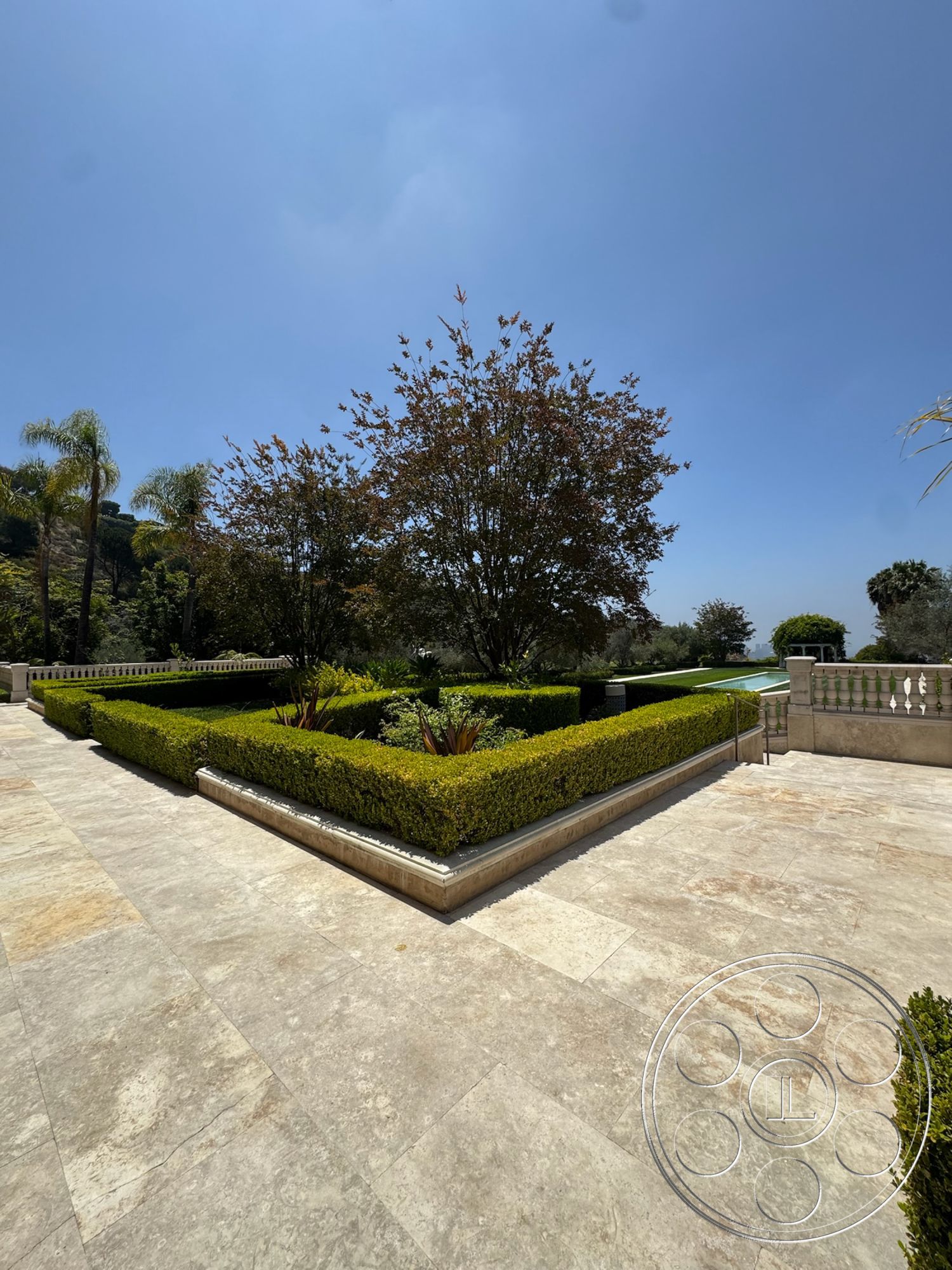 Beverly Compound - exterior, palm trees, serene atmosphere, rectangular garden layout, stone patio flooring, hedge garden borders, concrete garden retaining wall, landscaped green foliage, sunshine outdoor setting, view of the pool area