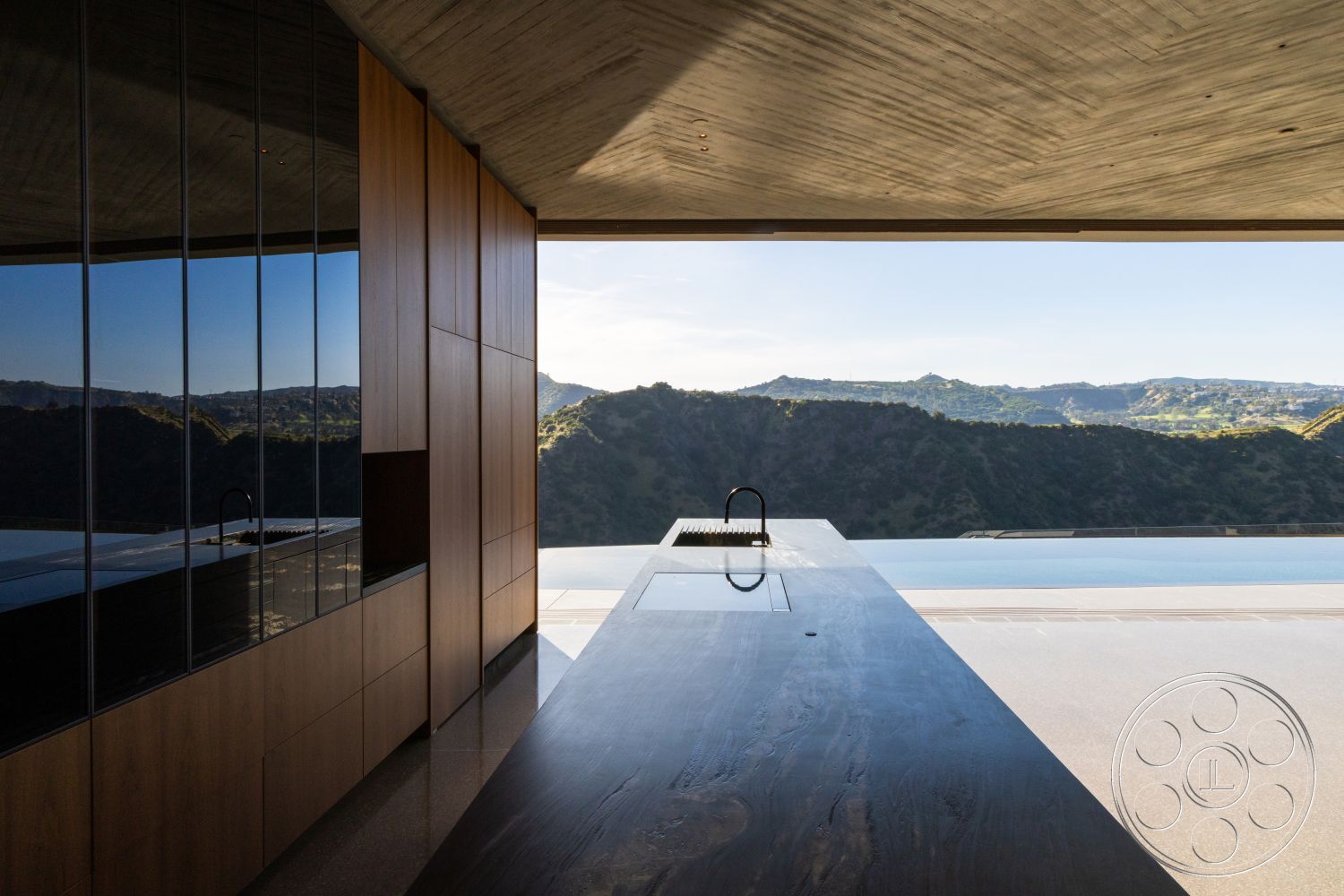Modern 516 - minimalist design, wood cabinetry, exposed concrete walls, floor-to-ceiling windows, modern architectural style, mountain view, concrete ceiling, rectangular kitchen island, glass wall panels, dark wood island countertop