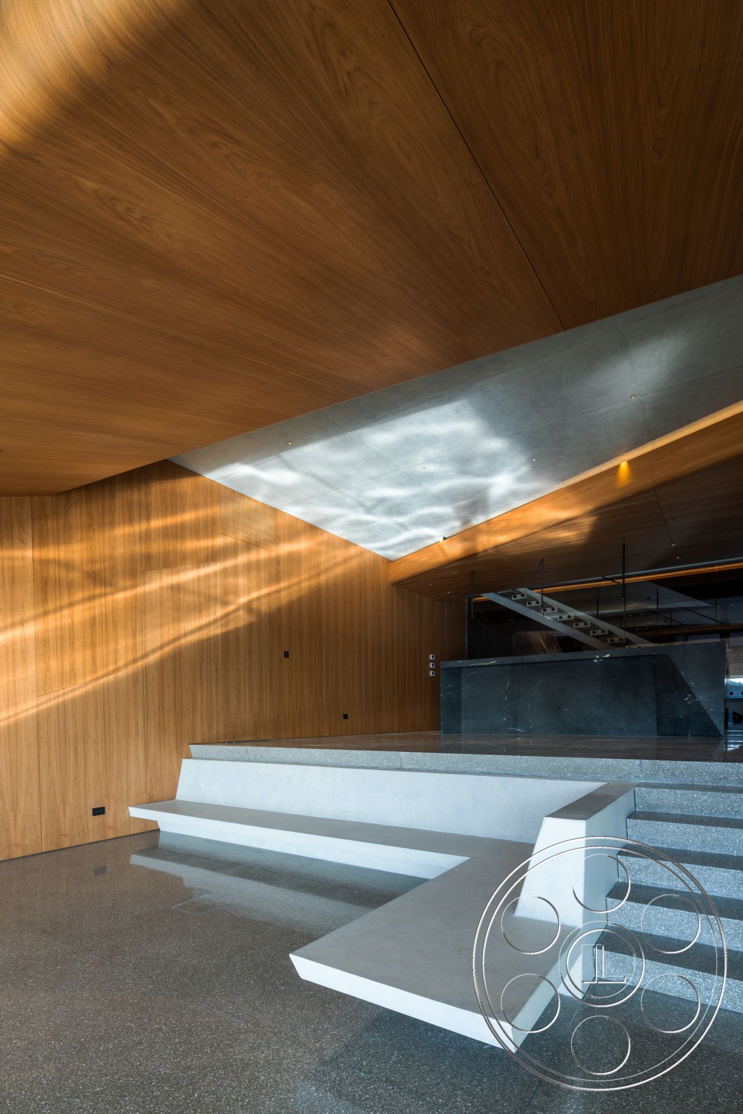 Modern 516 - polished concrete flooring, floor-to-ceiling windows, modern minimalist style, wood paneling ceiling, exposed concrete step seating, black stone kitchen island, linear geometric shapes, light and shadow interplay, angular architectural design