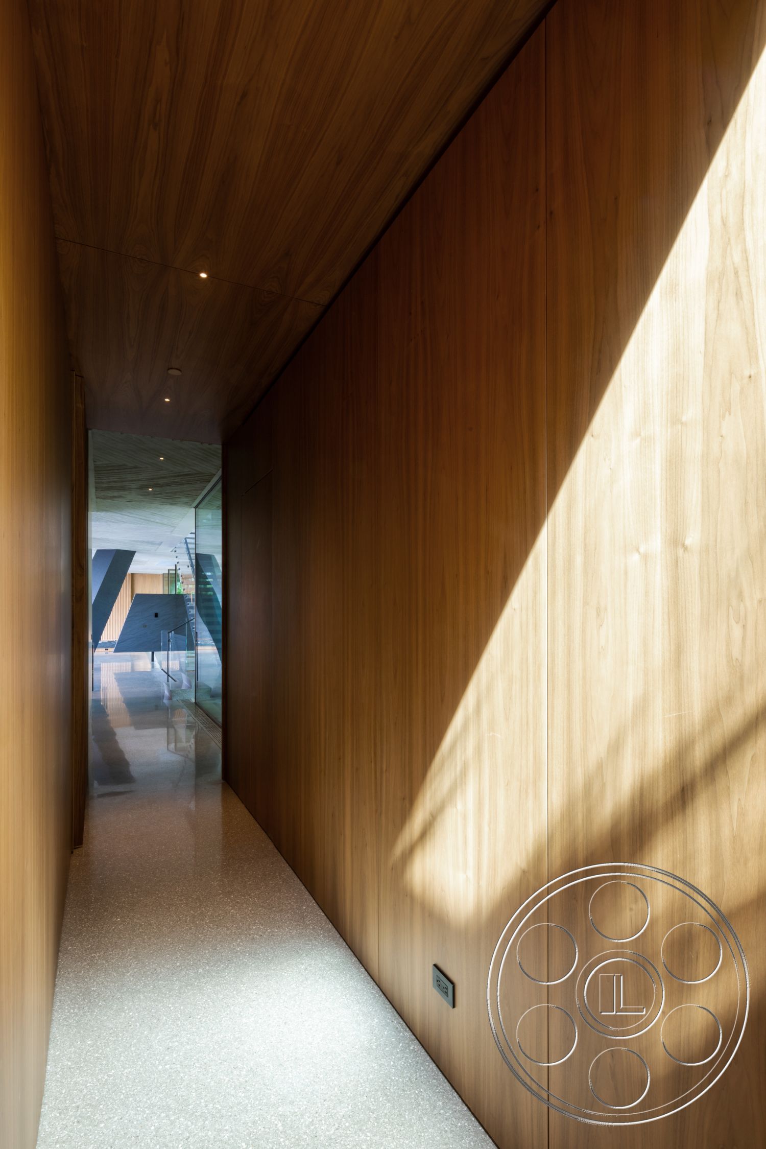 Modern 516 - exterior, exposed wooden ceiling, modern architectural style, natural light from windows, integrated lighting fixtures, wood paneling walls, linear hallway design, tile floor with terrazzo finish