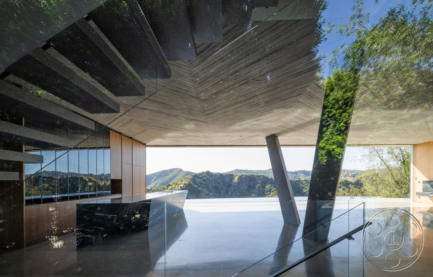 Modern 516 - open floor plan, polished concrete flooring, interior space, modern architectural style, exposed concrete ceiling, mountain view setting, floor-to-ceiling glass walls, wood panel accent wall, floating concrete staircase, steel glass railing