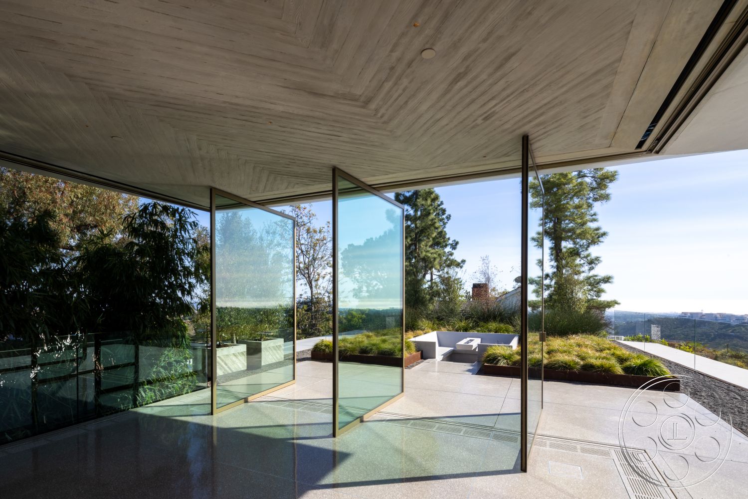 Modern 516 - natural lighting, minimalist aesthetic, polished concrete flooring, urban view, concrete ceiling, open-plan living space, modern architectural design, floor-to-ceiling glass doors, landscaped outdoor area, elevated hillside location, steel and glass railing