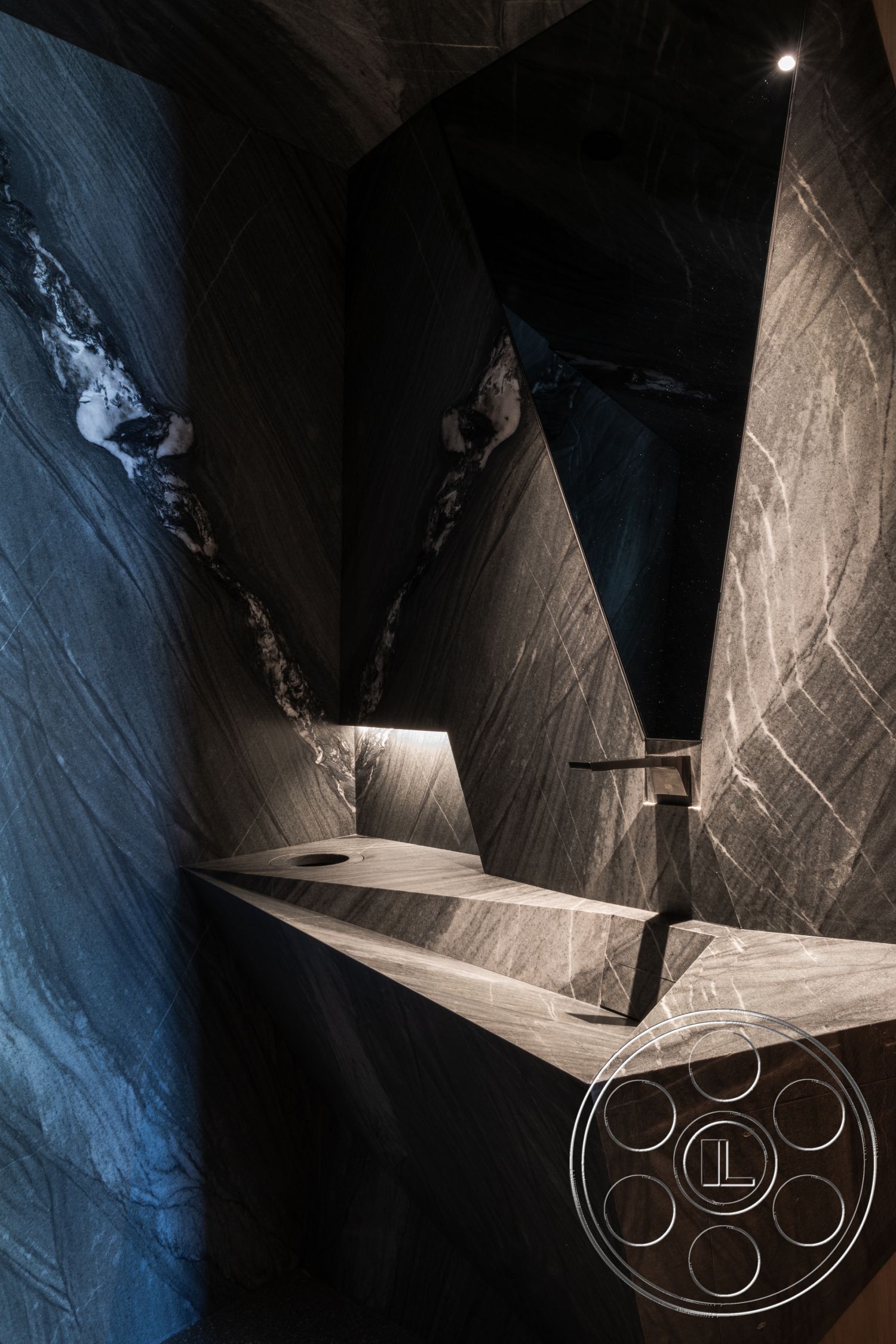 Modern 516 - minimalist design elements, luxurious finishes, contemporary bathroom, integrated lighting features, angular geometric shapes, dark marble wall treatments, slate stone sink, textured marble surfaces, faceted wall design