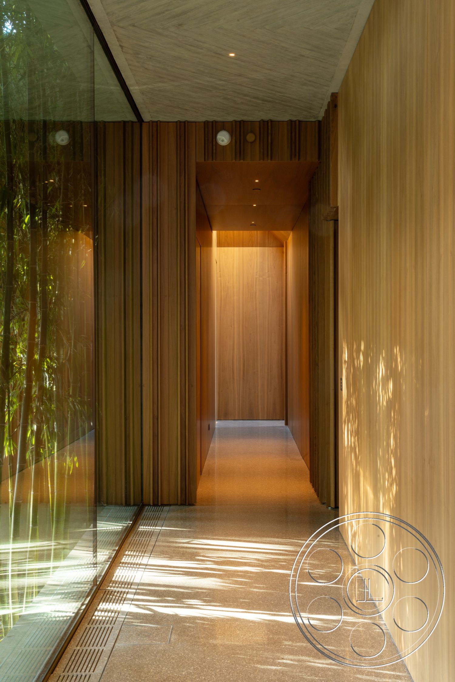 Modern 516 - minimalist design, polished concrete flooring, open concept layout, glass wall features, textured wall treatments, recessed ceiling lighting, wood paneling hallway walls, natural light from glass wall, streamlined shapes and forms