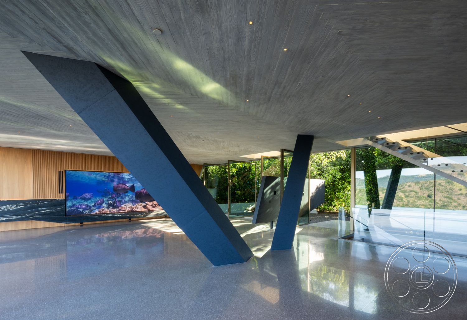 Modern 516 - exterior, open floor plan, polished concrete flooring, nature view, floor-to-ceiling windows, wood accent wall, exposed concrete ceiling, landscape integration, glass wall partitions, modern architectural design, steel structural beams, integrated audiovisual system, angled support columns