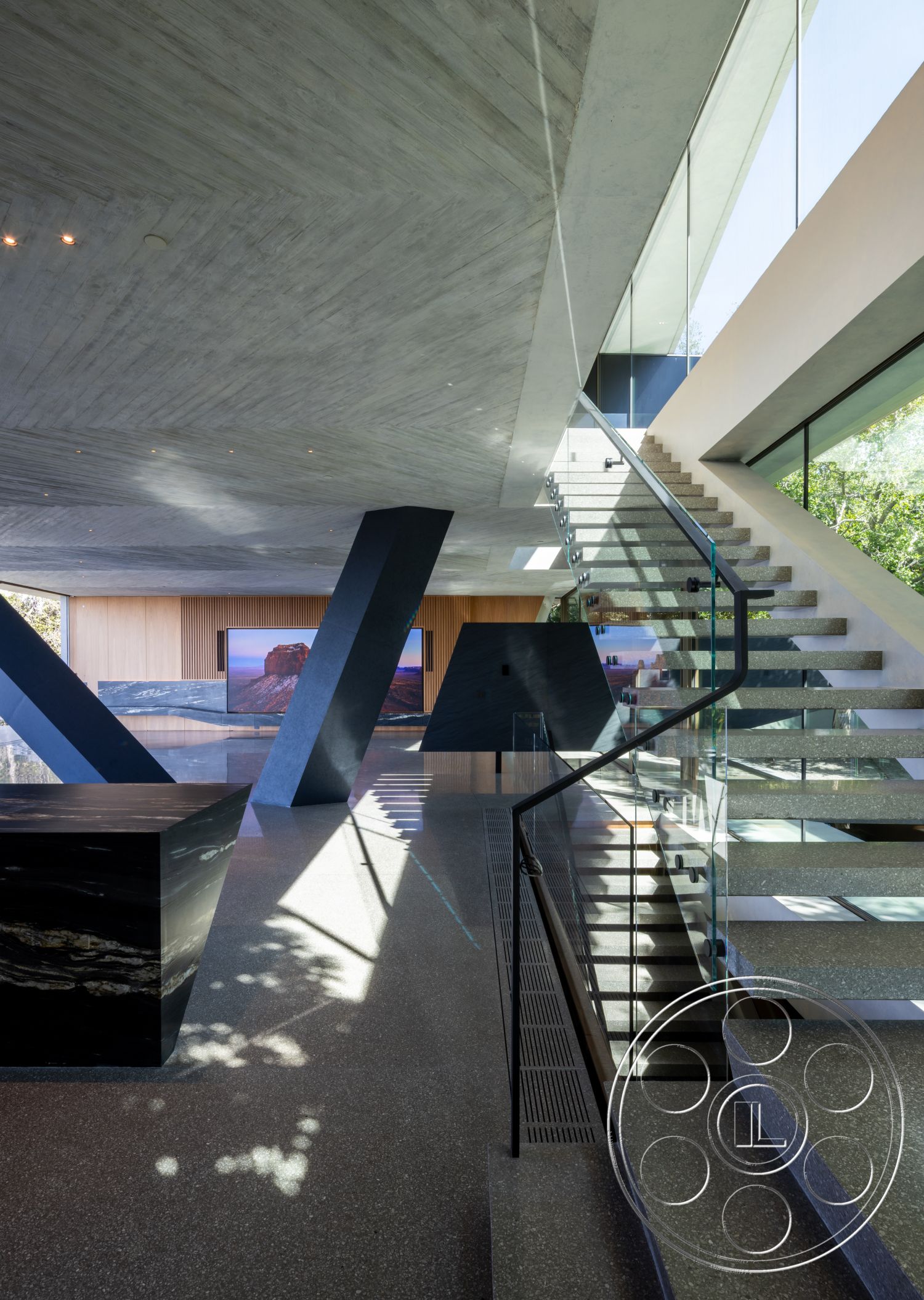 Modern 516 - open floor plan, polished concrete flooring, floor-to-ceiling windows, modern architectural style, exposed concrete ceiling, natural light illumination, wood panel accent wall, contemporary design details, glass stair railings, black stone kitchen island, steel staircase with floating steps, geometric supporting columns