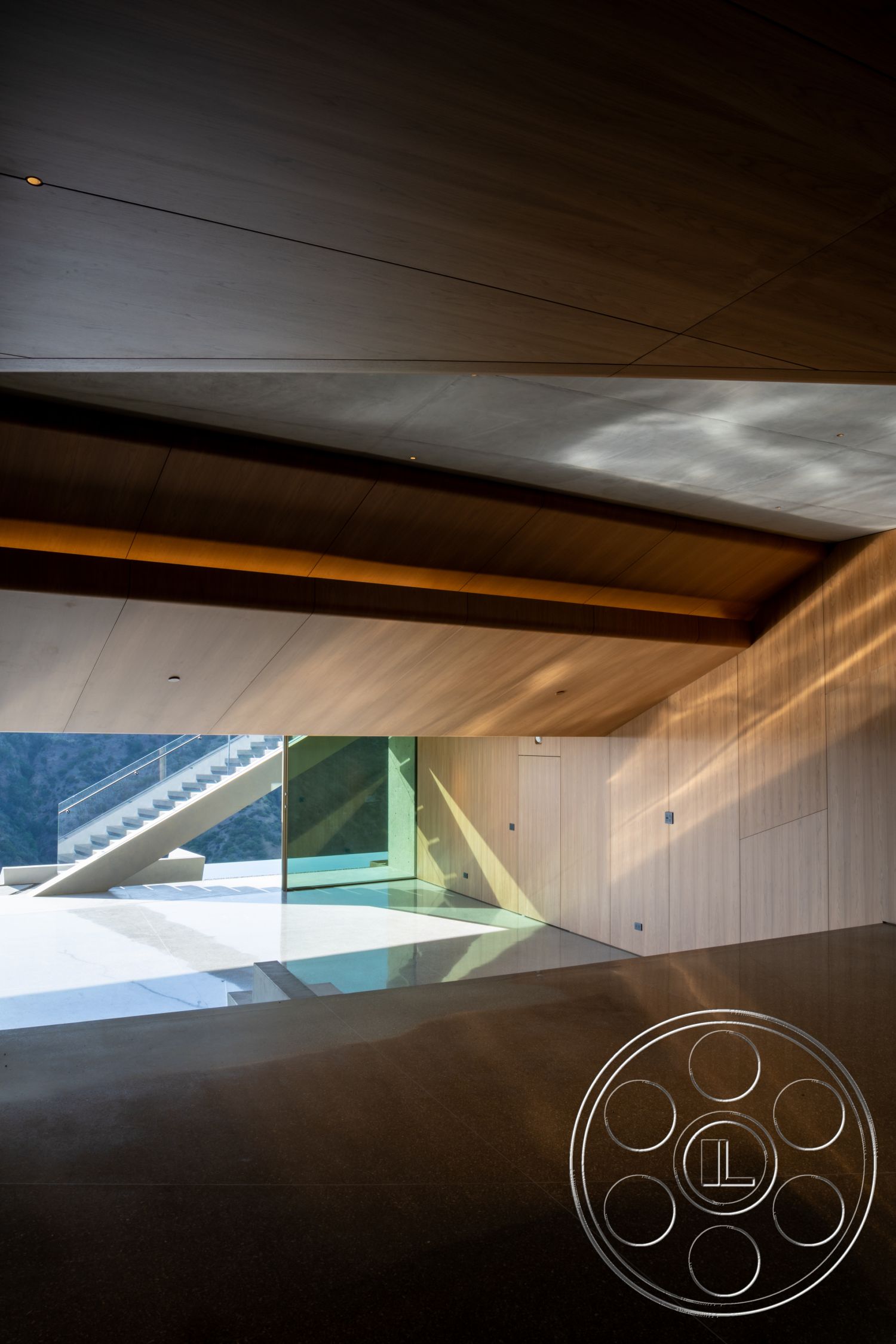 Modern 516 - minimalist design, concrete flooring, open space layout, sliding glass doors, textured wall panels, contemporary architecture, mountain view setting, floor-to-ceiling glass windows, natural light emphasis, exposed wood ceiling panels, angular ceiling shape
