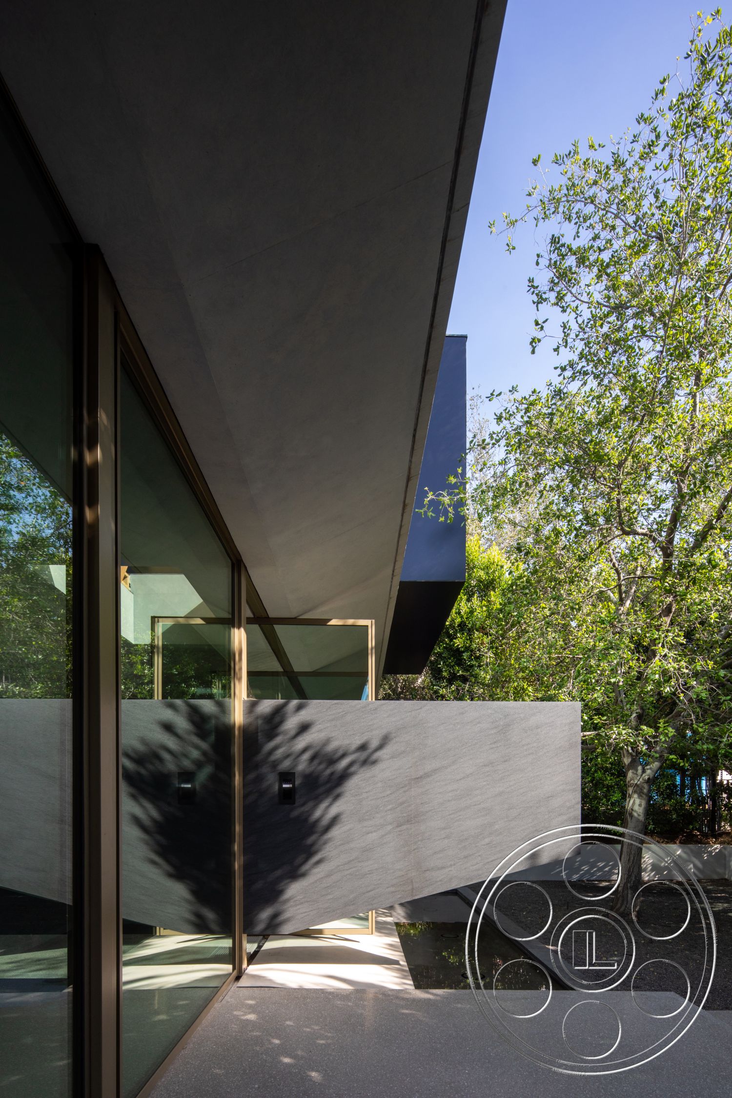 Modern 516 - natural light, exterior, modern architectural style, open-air design, contemporary outdoor space, textured concrete surface, landscaped garden area, concrete overhang, glazed windows with bronze frames, angular concrete wall