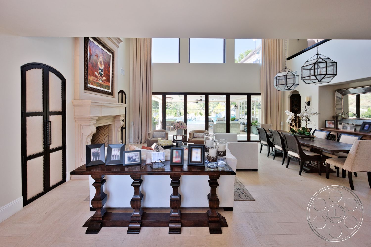 Hayden House - neutral color palette, large windows, natural light, exterior, open floor plan, upholstered dining chairs, glass sliding doors, framed artwork, high ceiling, textured wall panels, tiled floor, decorative pendant lighting, dark wooden dining table, stone fireplace surround, elegant living room, decorative table accessories, curtained window treatments