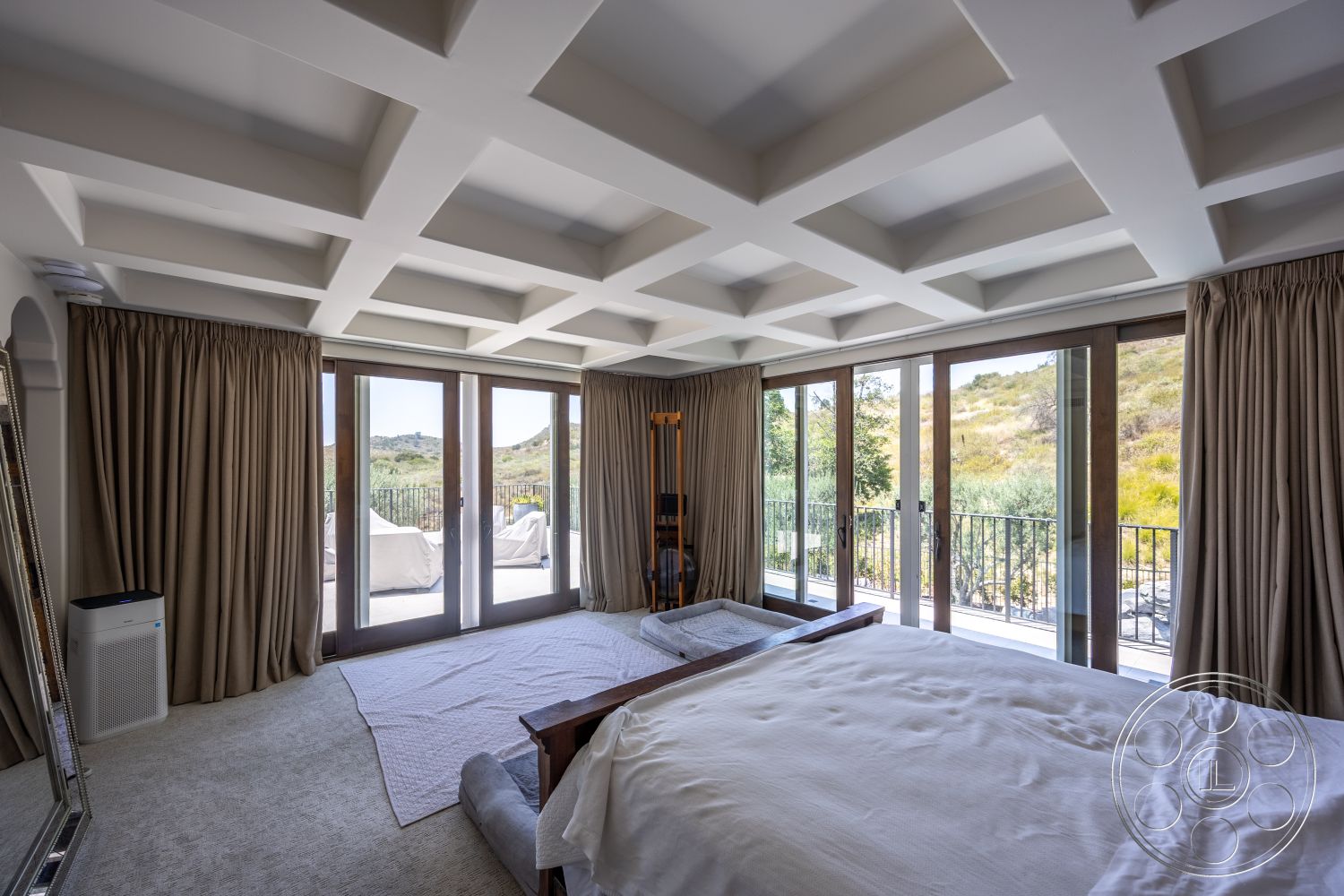 Hayden House - neutral color palette, coffered ceiling, sliding glass doors, floor-to-ceiling windows, mountain view, wooden bed frame, carpet bedroom flooring, curtained window treatments, spacious bedroom layout