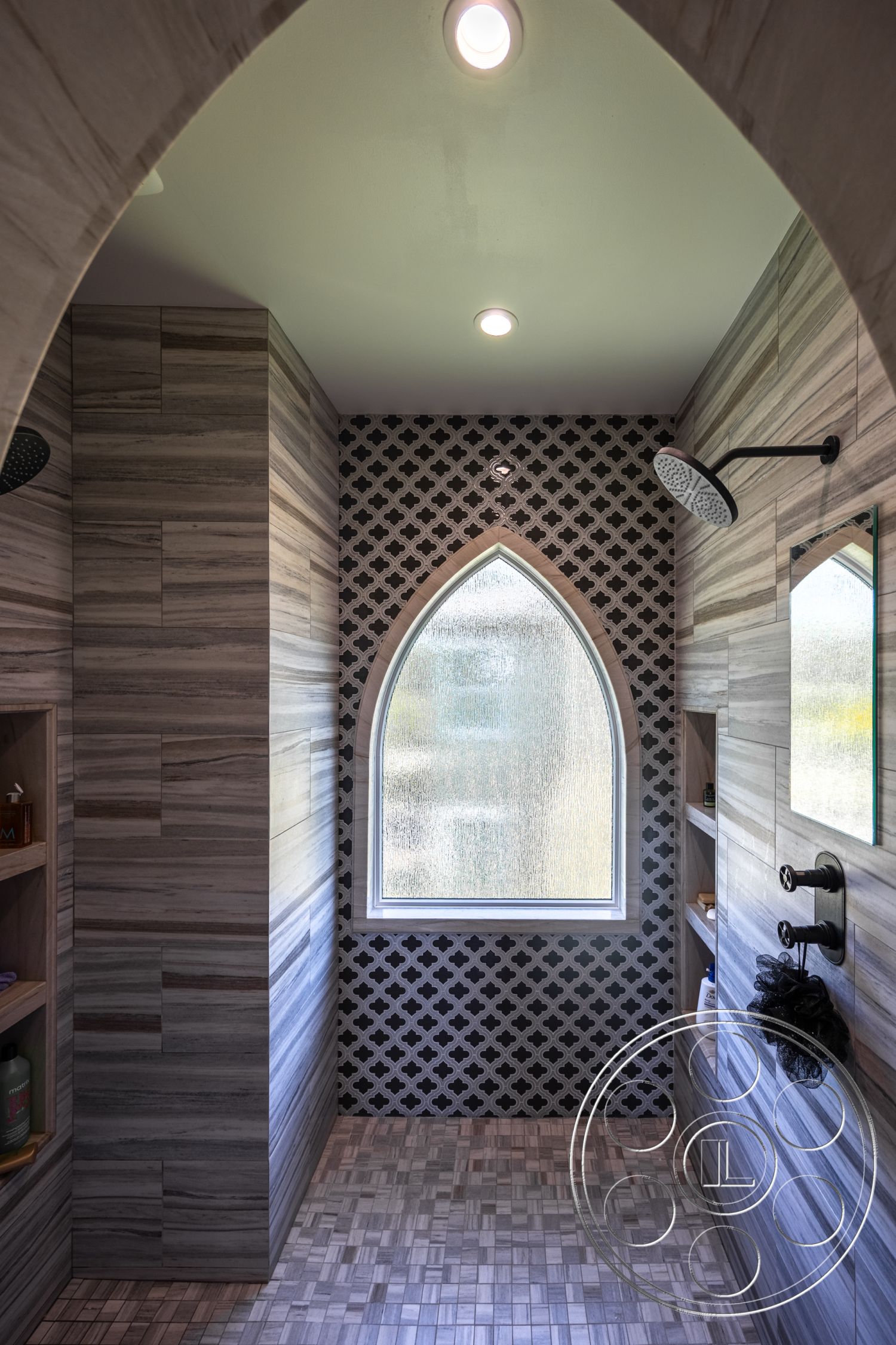 Hayden House - open shelving, modern shower fixtures, ceiling recessed lighting, wood plank flooring, wood panel shower walls, black patterned tile accent wall, arched shower window