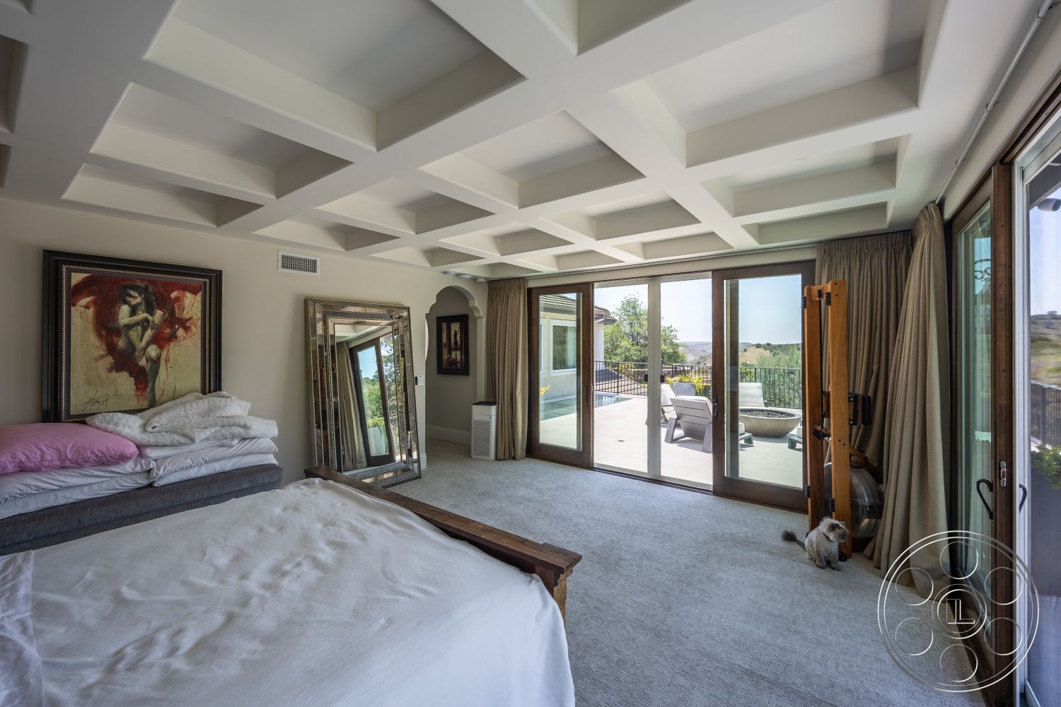 Hayden House - minimalist decor, coffered ceiling, framed artwork, textured wall treatments, elegant drapery, large sliding glass doors, luxury bedding, full-length mirror, carpet bedroom flooring, outdoor balcony view, modern bedroom design, milk chocolate wood window frames, opaque curtain panels, sliding patio door