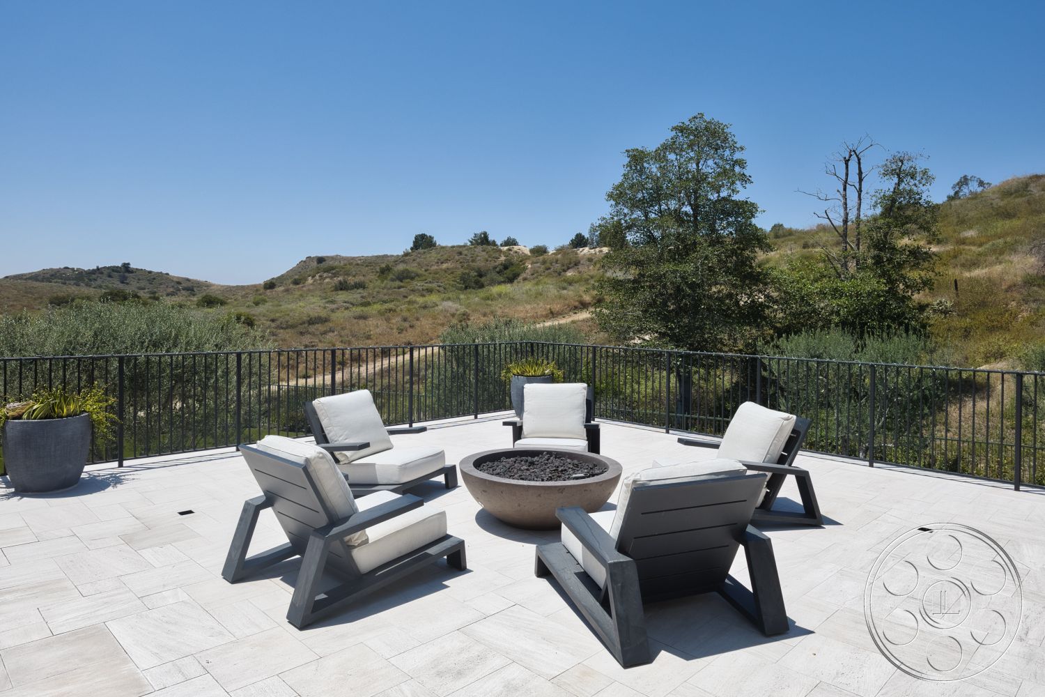 Hayden House - contemporary design, lush greenery, minimalist aesthetic, fire pit table, landscape view, metal railing, modern outdoor seating, stone patio flooring, interior outdoor space