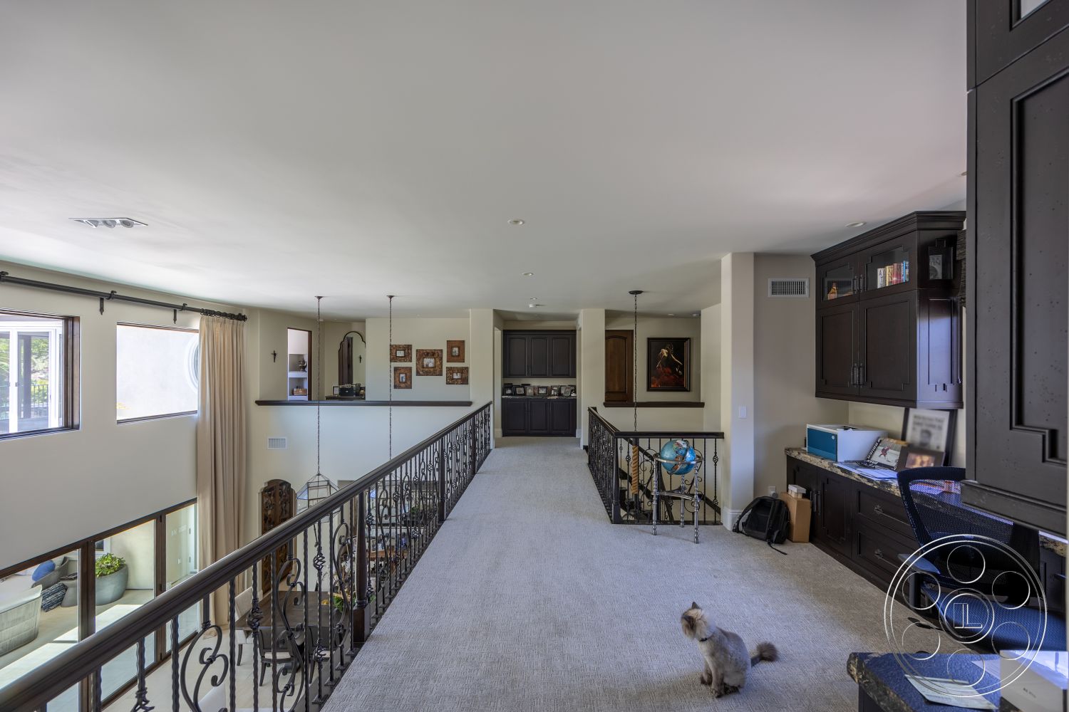 Hayden House - neutral color palette, recessed lighting, carpet flooring, decorative wall art, black cabinetry, white painted walls, exposed iron stair railings, open balcony layout, picture windows