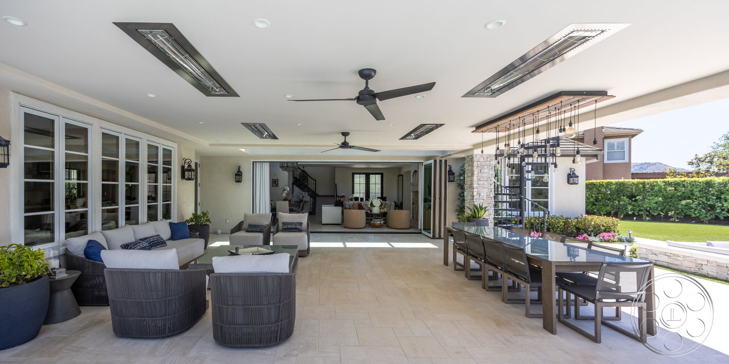 Hayden House - large windows, exterior, landscaped garden, open floor plan, modern light fixtures, indoor-outdoor flow, glass sliding doors, ceiling fan, textured wall finish, outdoor dining area, wooden ceiling beams, lush green lawn, contemporary outdoor furniture, rectangular dining table, stone patio flooring, safety railing, stainless steel stairs