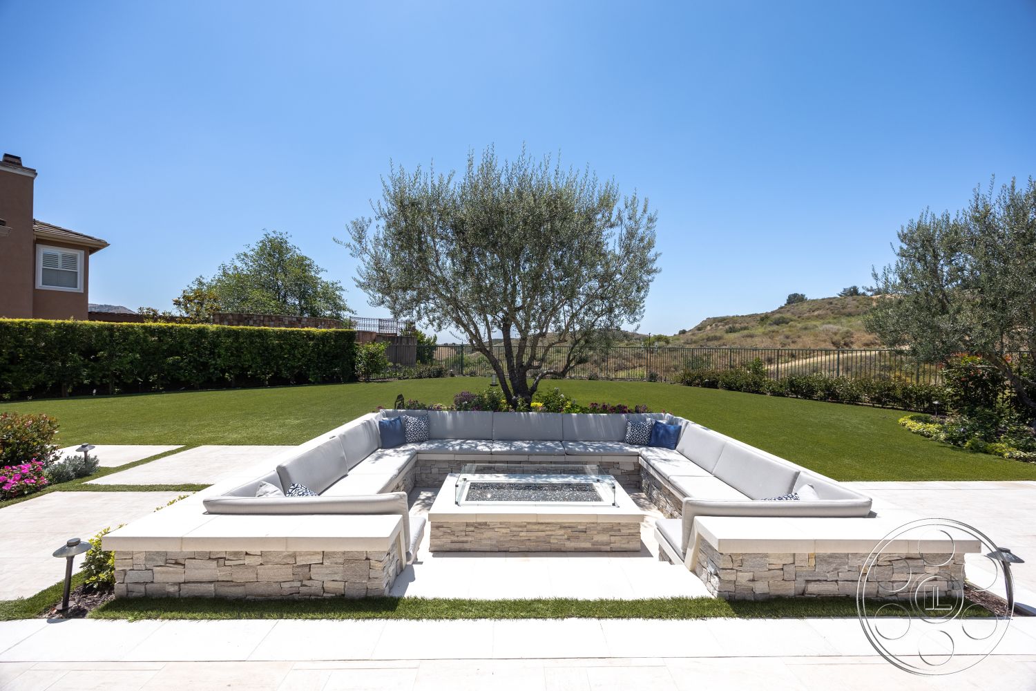 Hayden House - exterior, decorative potted plants, shade trees, concrete patio flooring, modern outdoor setting, rectangular fire pit, surrounding hillside view, sectional outdoor couch, stone fire pit seating area, landscape lawn area, stainless steel gas fire feature