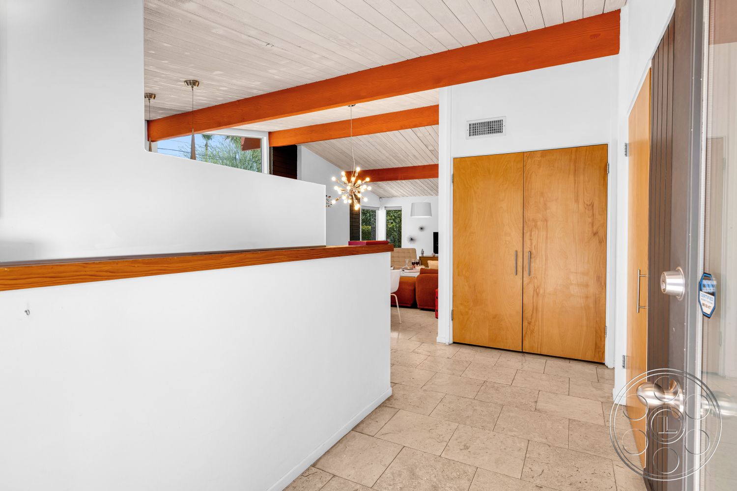 Palm Springs 76 - minimalist design, open floor plan, ceramic tile flooring, vaulted ceiling, modern light fixture, exposed wood ceiling beams, white painted walls, double wooden doors, wooden accent railing, bright entryway, contrast wood trim