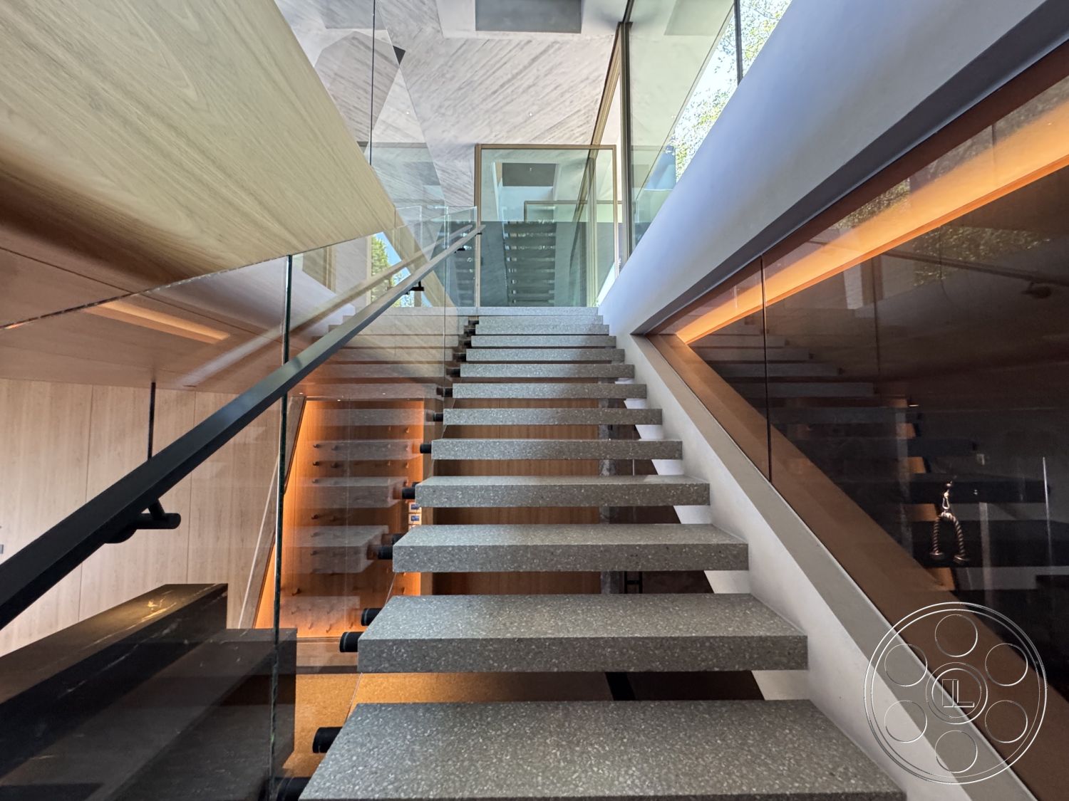 Modern 516 - natural light, minimalist aesthetic, modern design, wood paneling, open space layout, glass railing, geometric forms, floating concrete steps, interior stairway, backlit wall detail