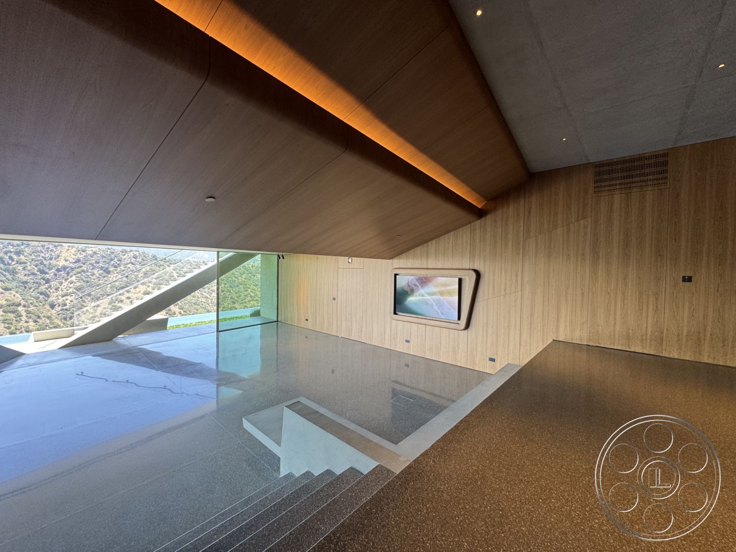 Modern 516 - open floor plan, polished concrete flooring, exposed structural elements, floor-to-ceiling glass windows, minimalist architectural style, integrated lighting features, sloped ceiling design, wood panel walls, terrazzo-like finish